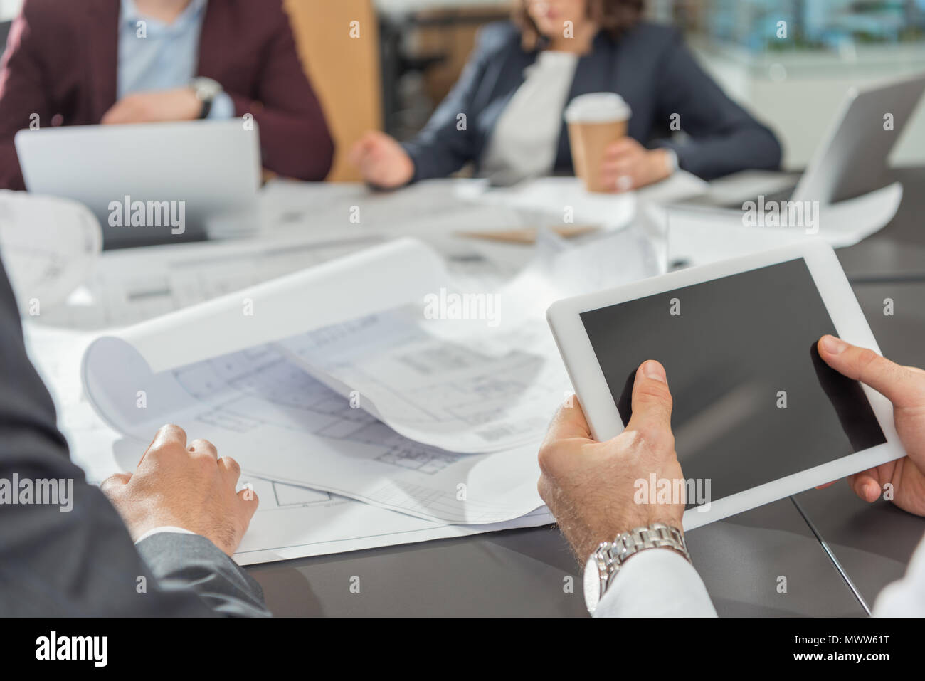 cropped shot of architect using tablet while having conference Stock Photo