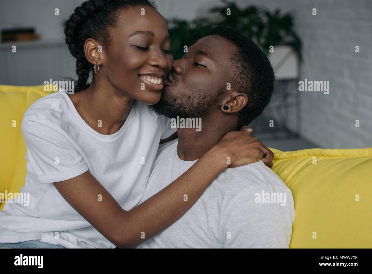 beautiful happy young african american couple hugging and kissing at ...
