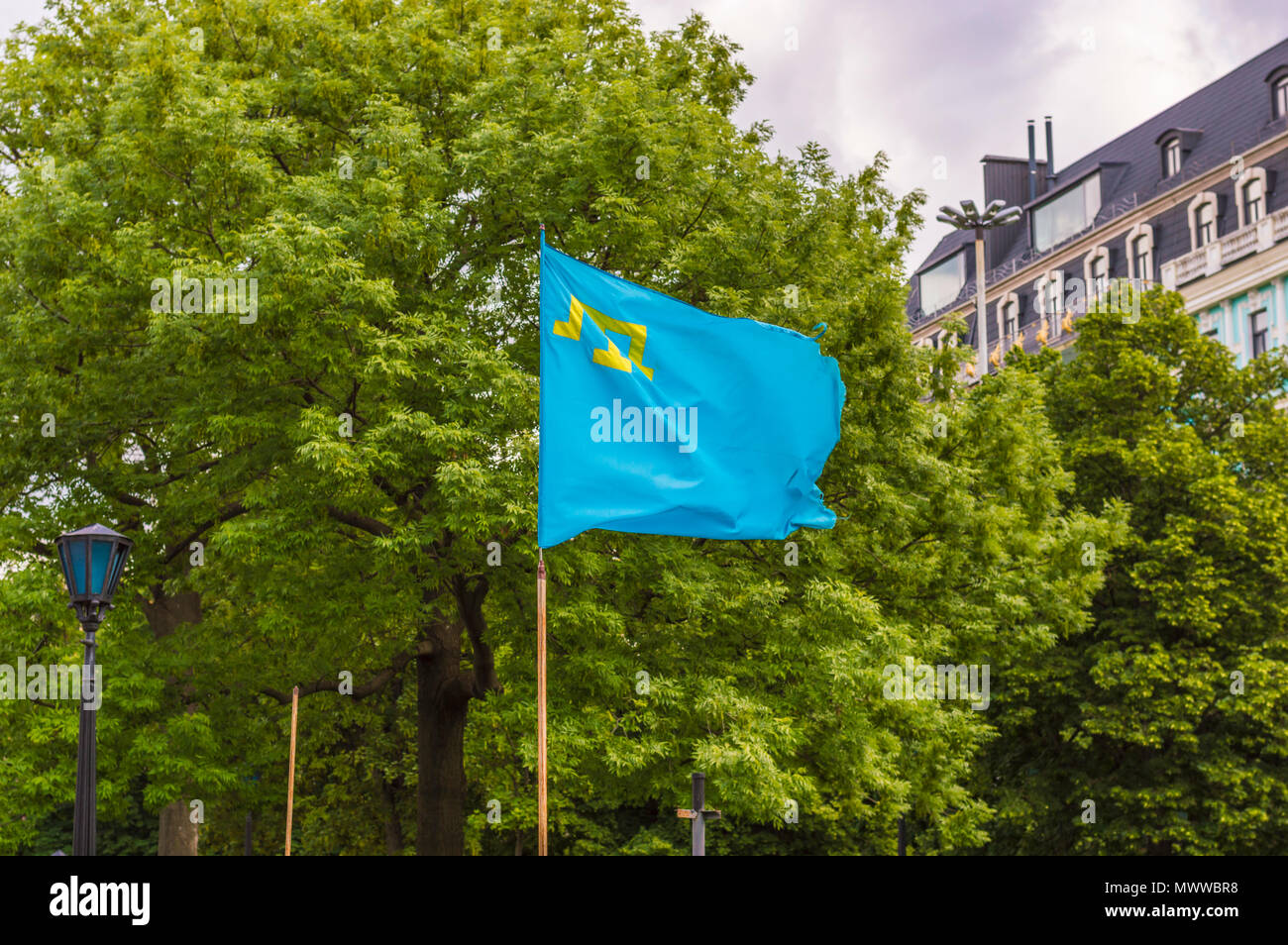 Crimean Tatar Flag in the Wind at Clowdy Day Stock Photo