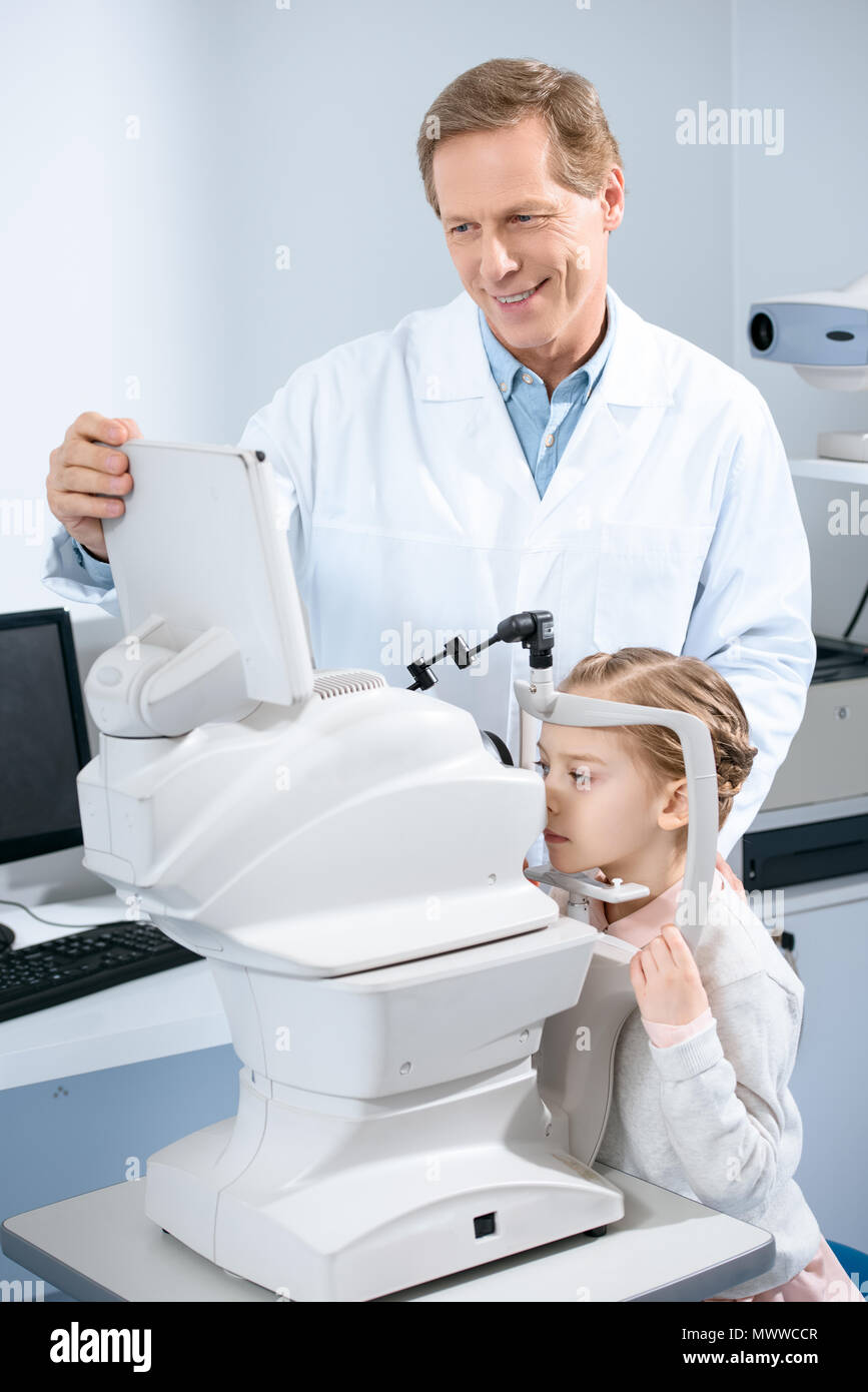 ophthalmologist examining vision of pre-adolescent child in clinic Stock Photo