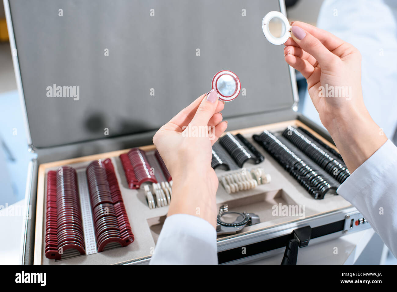 cropped view of ophthalmologist holding lenses for trial frame Stock Photo