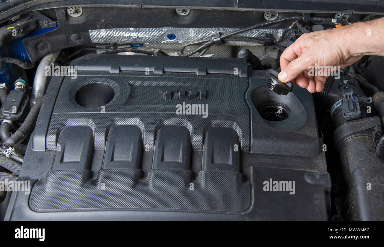 Hand is opening oil cap in diesel car Stock Photo Alamy