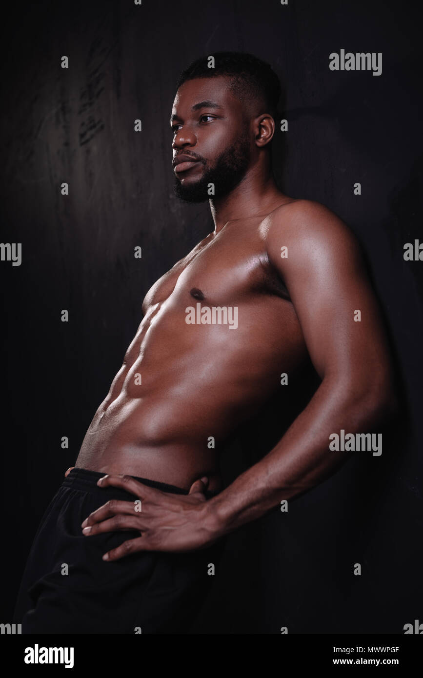 Portrait of shirtless muscular man standing with arms crossed Stock Photo -  Alamy