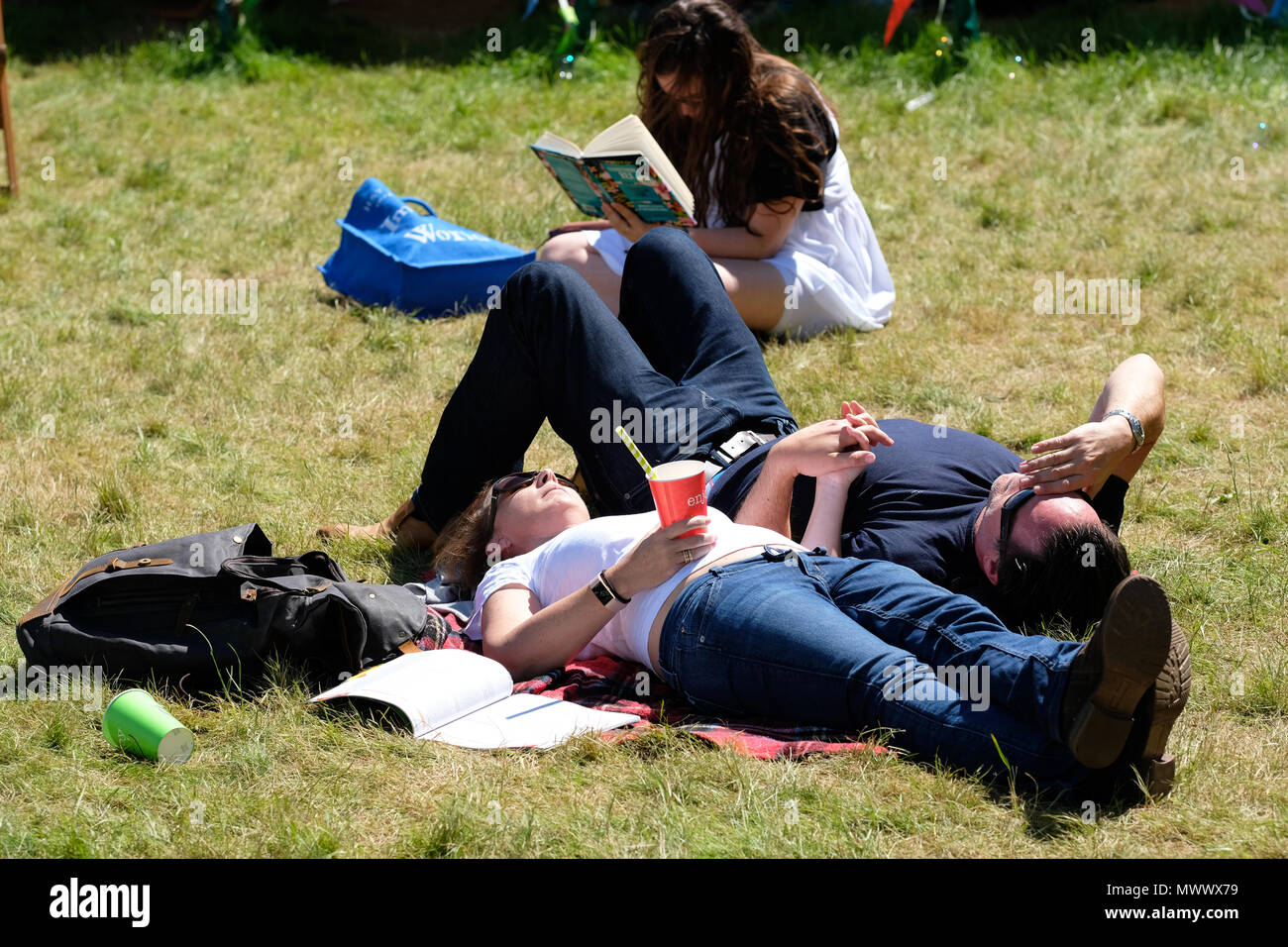 Hay on Wye, UK. 2nd June 2018.UK weather - Visitors enjoy the chance to sit and relax in warm sunshine on the Festival lawns between events and sessions with local temperatures of 22c  - The Hay Festival continues to Sunday 3rd June - Photo Steven May / Alamy Live News Stock Photo