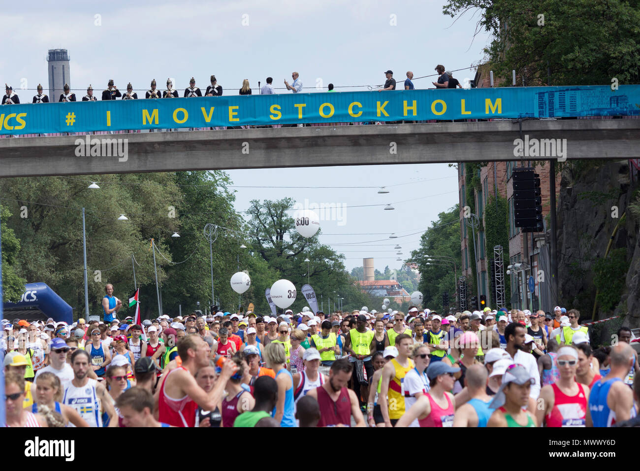 Stockholm (ASICS STHLM) Marathon 2018. Thousands of runners (from the first  of the two running groups) waiting under the bridge opposite Stockholm's  Stadium for the starting singal. The musketeers of the Royal