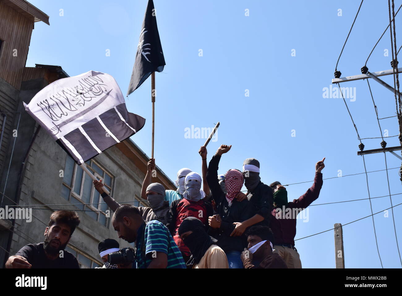 Srinagar, J&K, India. 2nd June 2018.  Kashmiri masked youths shouts anti Indian slogans near body of Qaiser Amin Bhat, during his funeral in Srinagar, Indian controlled Kashmir, on Saturday. Government forces in Indian-controlled Kashmir Saturday fired shotgun pellets and tear gas at hundreds of mourners in the disputed region's main city as they carried the body of a young man killed the other day after a paramilitary vehicle run over him, police and residents said. Credit: Abbas Idrees/SOPA Images/ZUMA Wire/Alamy Live News Credit: ZUMA Press, Inc./Alamy Live News Stock Photo