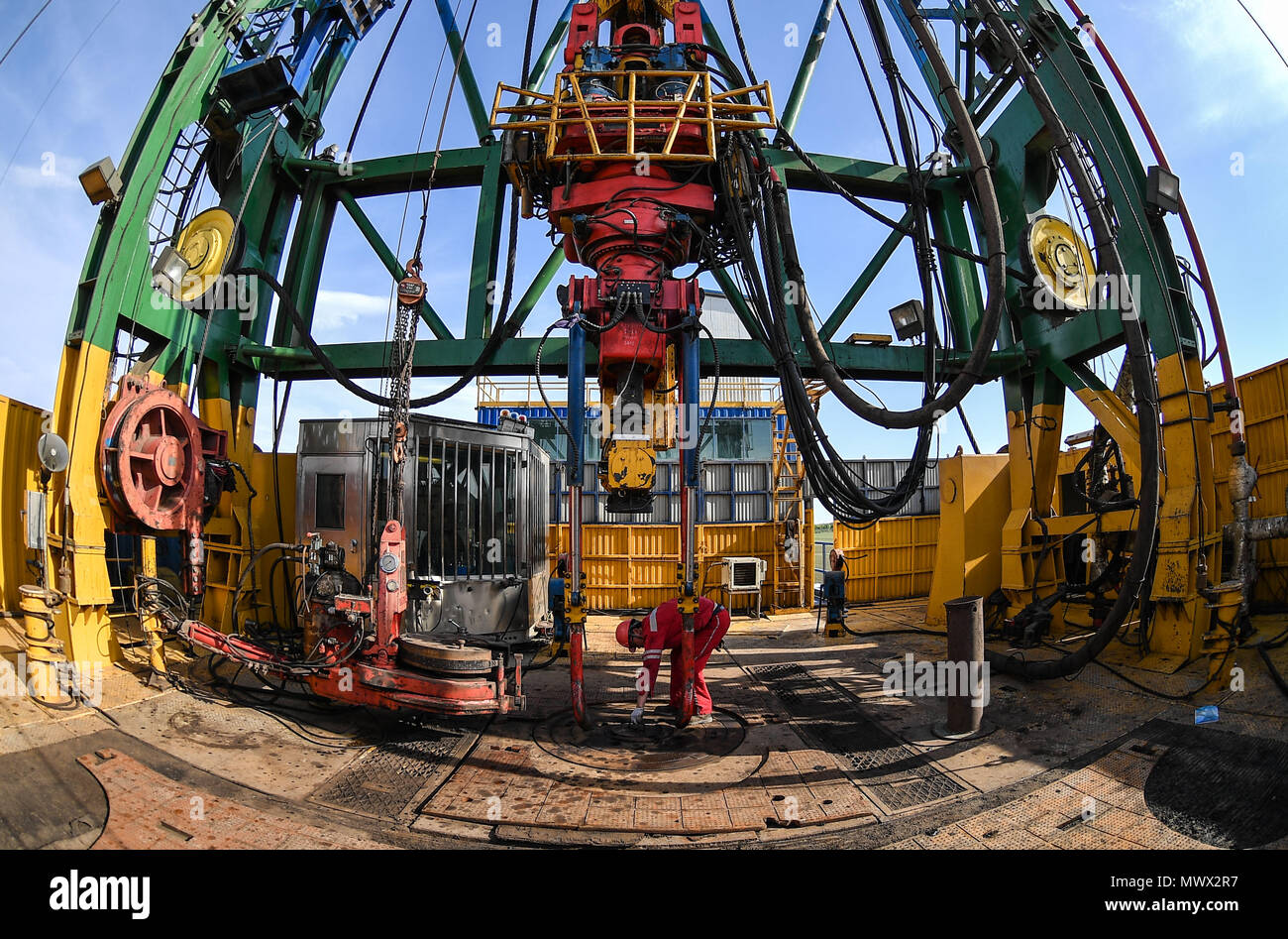 Changchun, China. 1st June, 2018. A worker conducts machinery check on the Crust 1 land-based drilling rig system in the Songliao Basin in northeast China, June 1, 2018. Crust 1, a land-based drilling rig, concluded its first mission on Saturday, putting China among the frontrunners in onshore drilling, along with Germany and Russia. Jointly developed by Jilin University and Sichuan-based Honghua Group, Crust 1 can dig as deep as 10,000 meters and is China's most advanced land-based drilling rig. Credit: Xu Chang/Xinhua/Alamy Live News Stock Photo