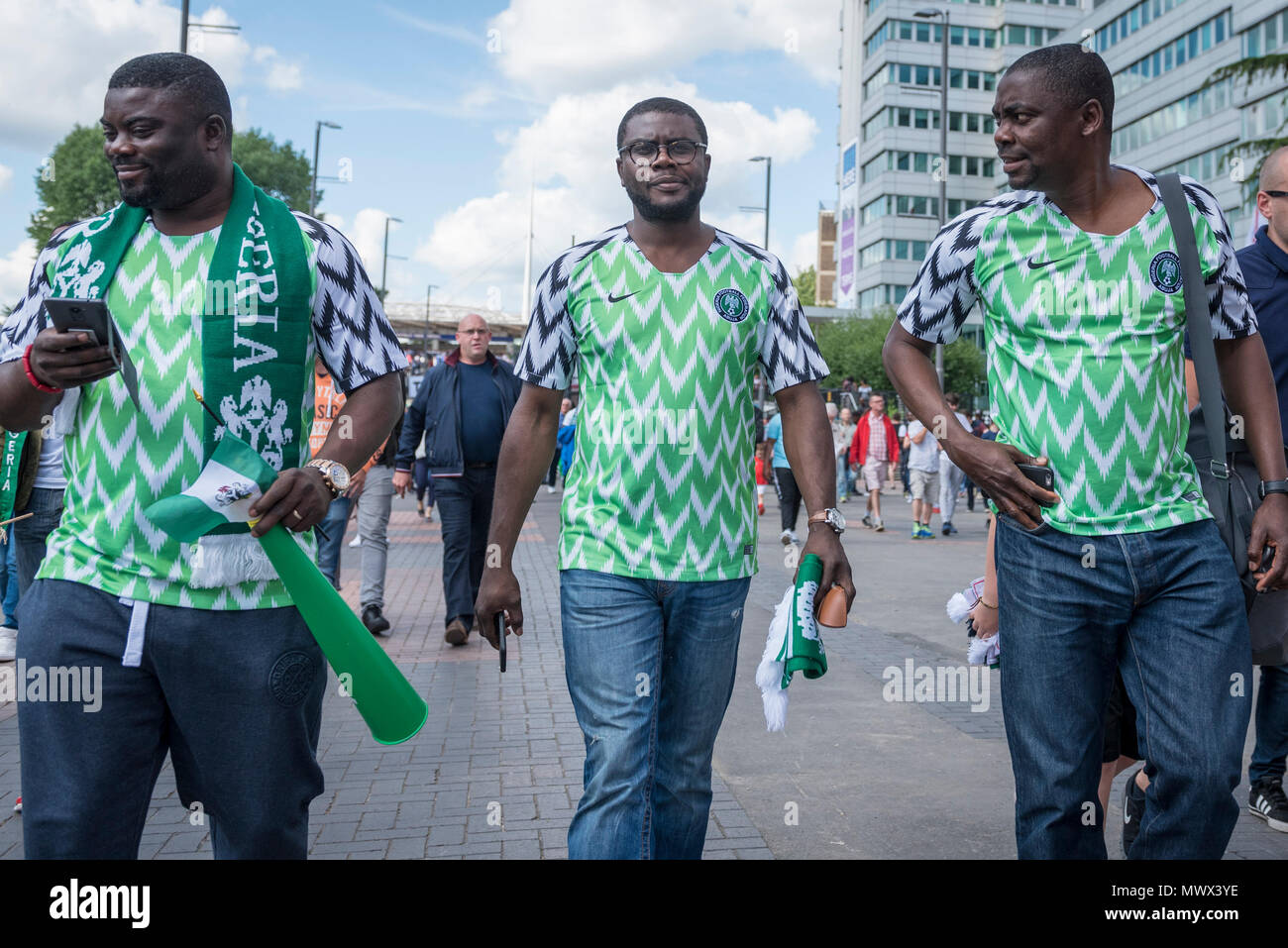 London, UK.  2 June 2018.  Nigerian fans wear the country's latest replica shirt, which bears a feathered pattern referencing the Nigerian team which made its debut in the 1994 World Cup.  3 million replica shirts have sold on pre-order alone with others selling out in minutes online. Fans arrive for the friendly football match between England and Nigeria at Wembley Stadium, the final match at Wembley before England travel to the World Cup in Russia  Credit: Stephen Chung / Alamy Live News Stock Photo