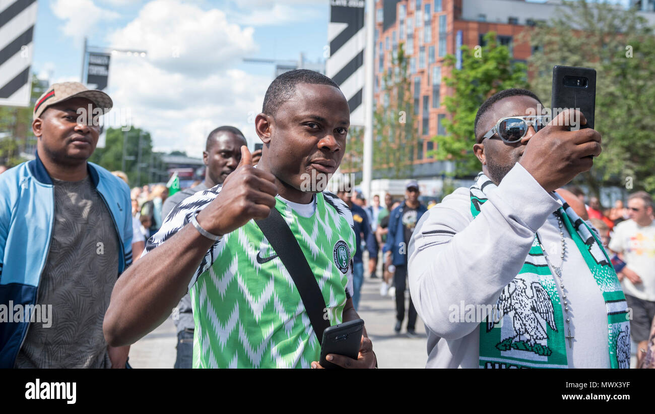 London, UK.  2 June 2018.  Nigerian fans wear the country's latest replica shirt (C), which bears a feathered pattern referencing the Nigerian team which made its debut in the 1994 World Cup.  3 million replica shirts have sold on pre-order alone with others selling out in minutes online. Fans arrive for the friendly football match between England and Nigeria at Wembley Stadium, the final match at Wembley before England travel to the World Cup in Russia  Credit: Stephen Chung / Alamy Live News Stock Photo