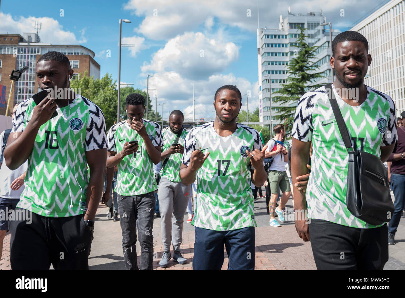 London, UK.  2 June 2018.  Nigerian fans wear the country's latest replica shirt, which bears a feathered pattern referencing the Nigerian team which made its debut in the 1994 World Cup.  3 million replica shirts have sold on pre-order alone with others selling out in minutes online. Fans arrive for the friendly football match between England and Nigeria at Wembley Stadium, the final match at Wembley before England travel to the World Cup in Russia  Credit: Stephen Chung / Alamy Live News Stock Photo