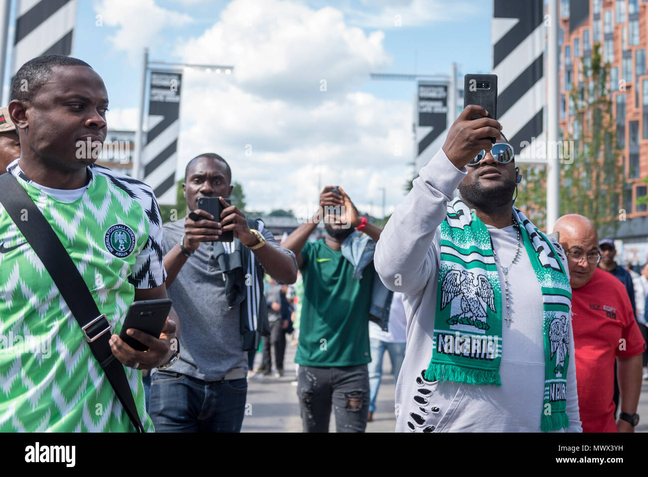 London, UK.  2 June 2018.  Nigerian fans wear the country's latest replica shirt (L), which bears a feathered pattern referencing the Nigerian team which made its debut in the 1994 World Cup.  3 million replica shirts have sold on pre-order alone with others selling out in minutes online. Fans arrive for the friendly football match between England and Nigeria at Wembley Stadium, the final match at Wembley before England travel to the World Cup in Russia  Credit: Stephen Chung / Alamy Live News Stock Photo