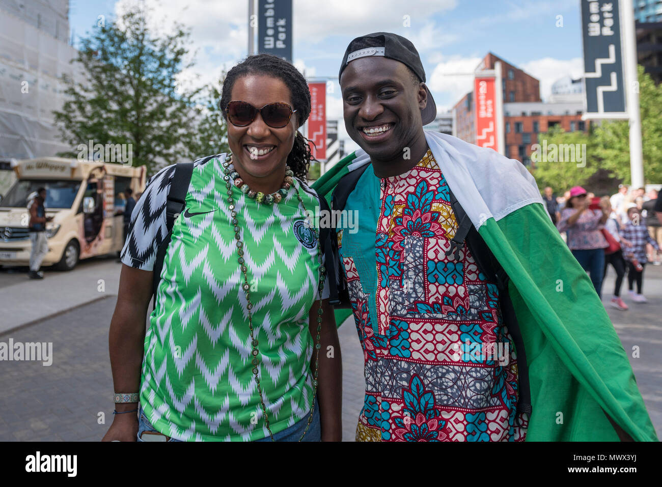 London, UK.  2 June 2018.  A Nigerian fan (L) wears the country's latest replica shirt, which bears a feathered pattern referencing the Nigerian team which made its debut in the 1994 World Cup.  3 million replica shirts have sold on pre-order alone with others selling out in minutes online. Fans arrive for the friendly football match between England and Nigeria at Wembley Stadium, the final match at Wembley before England travel to the World Cup in Russia  Credit: Stephen Chung / Alamy Live News Stock Photo