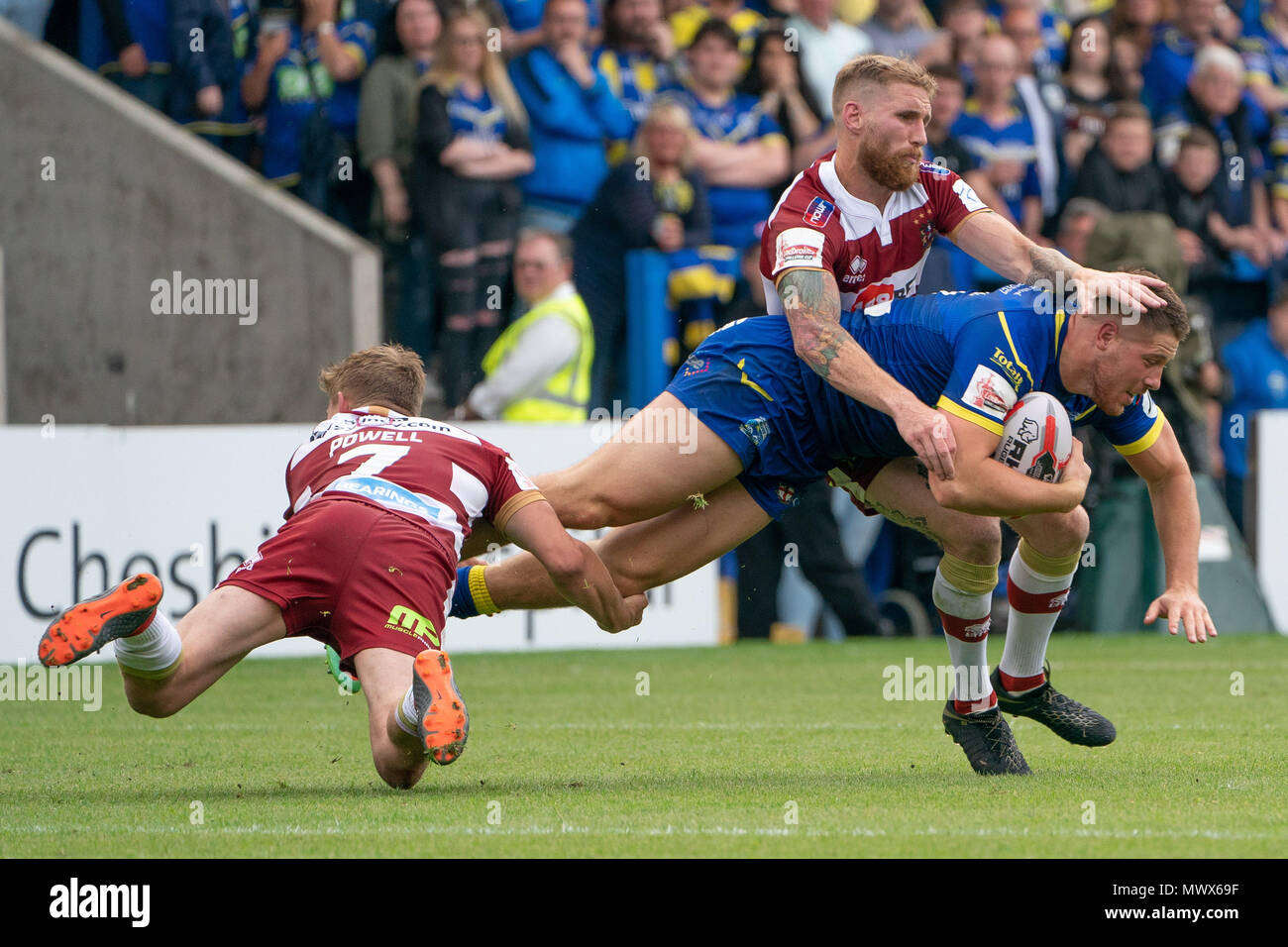 Warrington, UK. 2nd June 2018. Warrington Wolves's Tom Lineham is tackled by Wigan Warriors's Sam Tomkins (R) and Wigan Warriors's Sam Powell (L)   2nd June 2018 , The Halliwell Jones Stadium, Warrington, England; Quarter Final Ladbrokes Challenge Cup, Warrington Wolves v Wigan Warriors; Credit: News Images /Alamy Live News Stock Photo