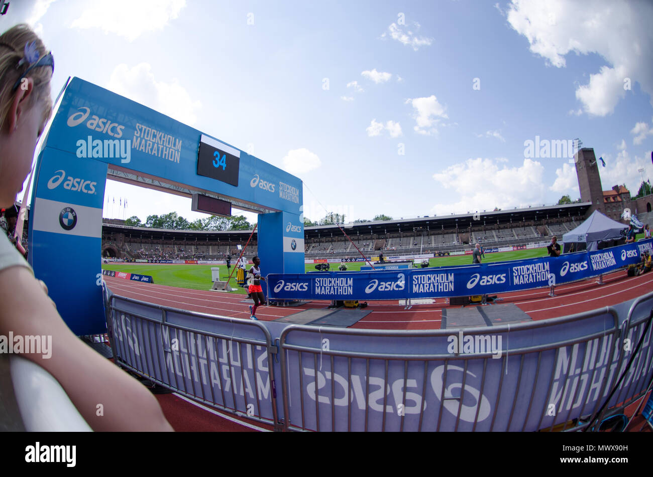 Stockholm, Sweden - 2 June 2018. The fourth-placed runner in the womens competition, Isabellah Andersson from Sweden, crossing the finish line at the 40th Stockholm marathon in very hot conditions Credit: Jari Juntunen/Alamy Live News Stock Photo