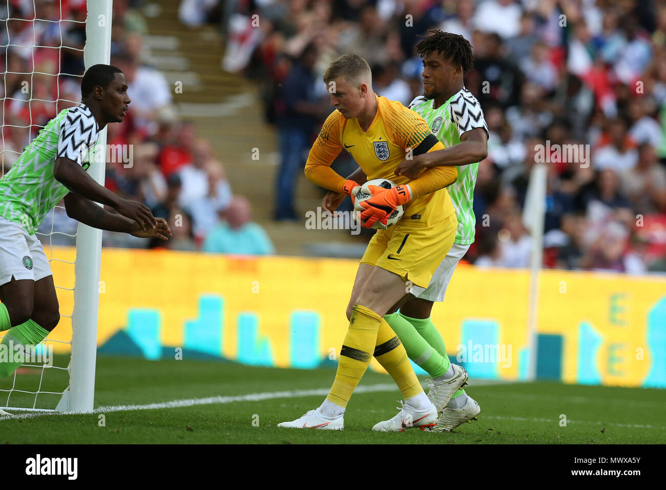 Wembley Stadium, London, UK. 2nd Jun, 2018. Alex Iwobi and Odion Ighalo of Nigeria try to get the ball off England goalkeeper Jordan Pickford after Iwobi of Nigeria scores his teams 1st goal. Football International friendly, England v Nigeria at Wembley Stadium in London on Saturday 2nd June 2018.  this image may only be used for Editorial purposes. Editorial use only, license required for commercial use. No use in betting, games or a single club/league/player publications. pic by Andrew Orchard//Andrew Orchard sports photography/Alamy Live news Stock Photo