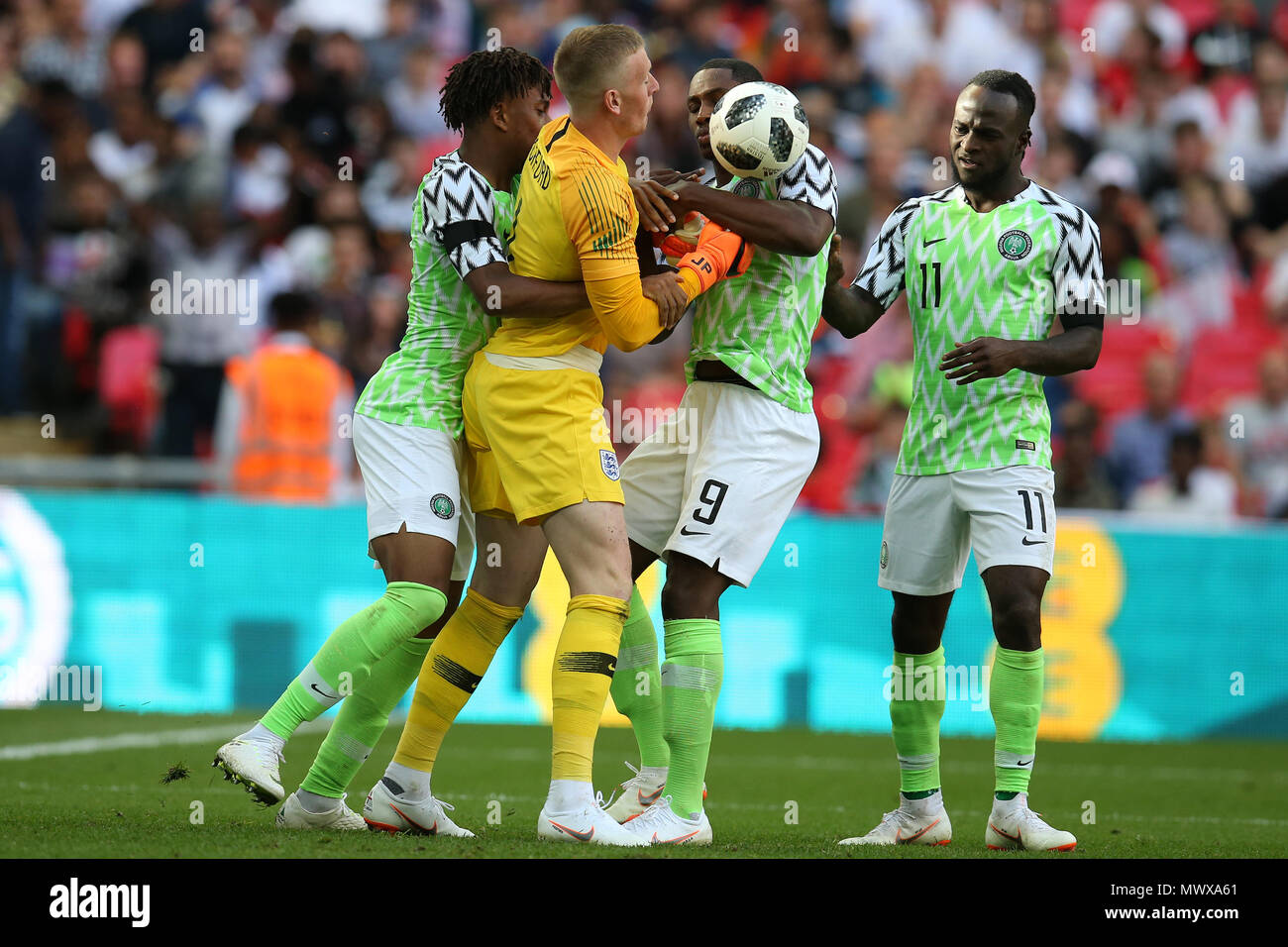 Wembley Stadium, London, UK. 2nd Jun, 2018. Alex Iwobi (l) and Odion Ighalo of Nigeria try to get the ball off England goalkeeper Jordan Pickford after Iwobi of Nigeria scores his teams 1st goal. Football International friendly, England v Nigeria at Wembley Stadium in London on Saturday 2nd June 2018.  this image may only be used for Editorial purposes. Editorial use only, license required for commercial use. No use in betting, games or a single club/league/player publications. pic by Andrew Orchard//Andrew Orchard sports photography/Alamy Live news Stock Photo