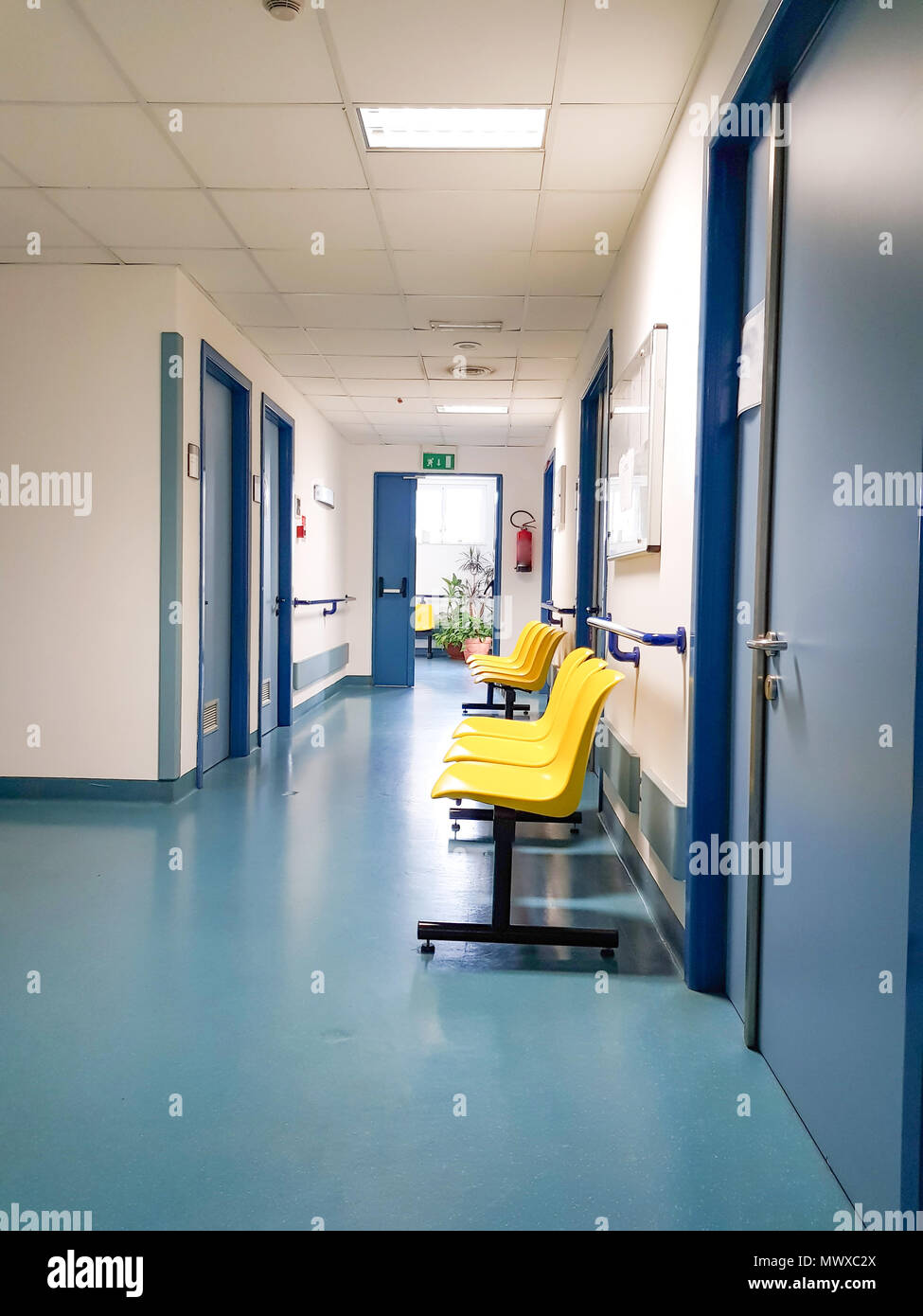 Chairs in the hospital hallway, hospital interior, Empty chairs for waiting in hospital. Stock Photo