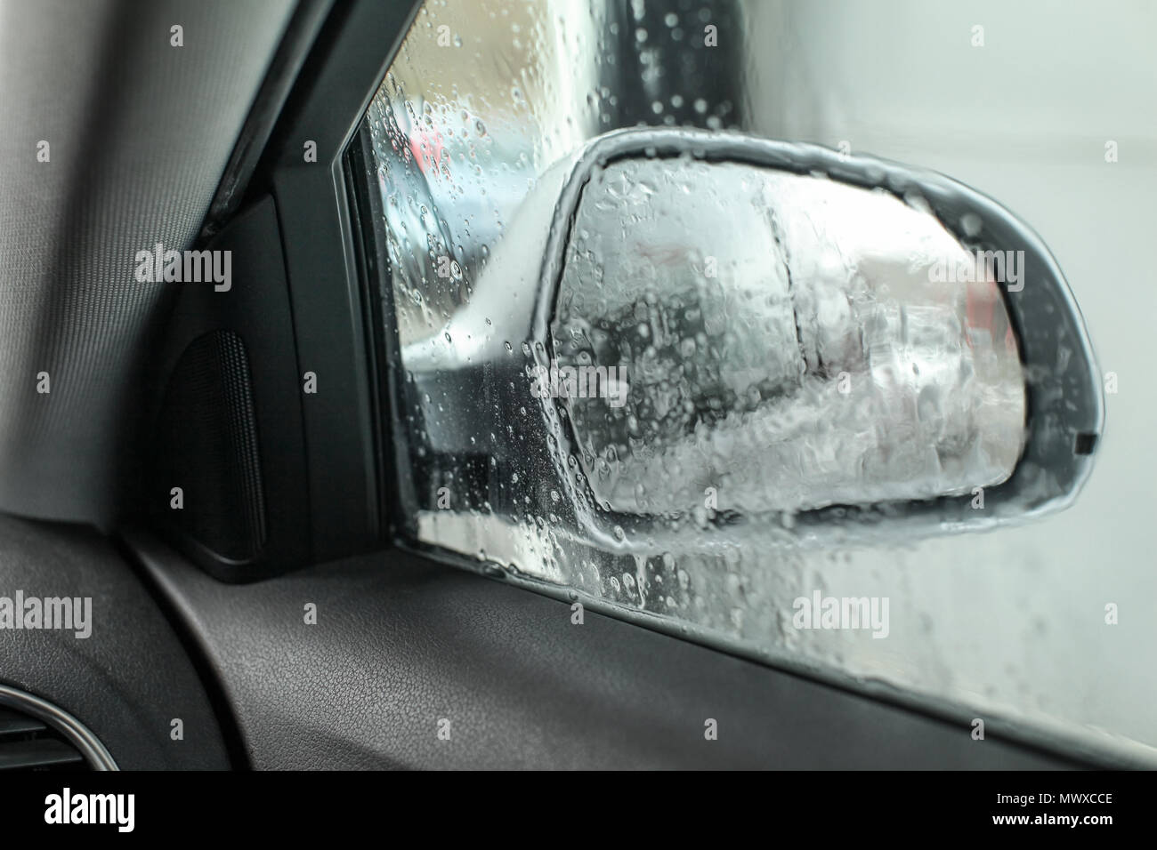 View From Inside The Car Looking At Side Mirror Wet From Water