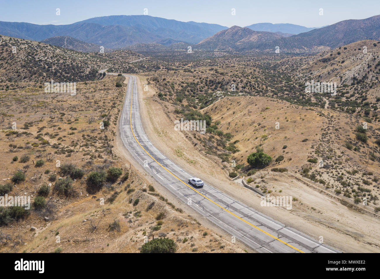 Single car on empty wilderness road in the Mojave Desert of southern