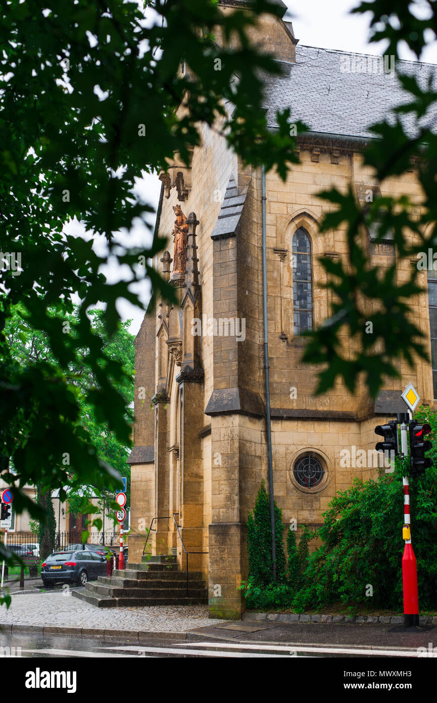 Historical church scene through the trees in a rainy day, Luxembourg ...