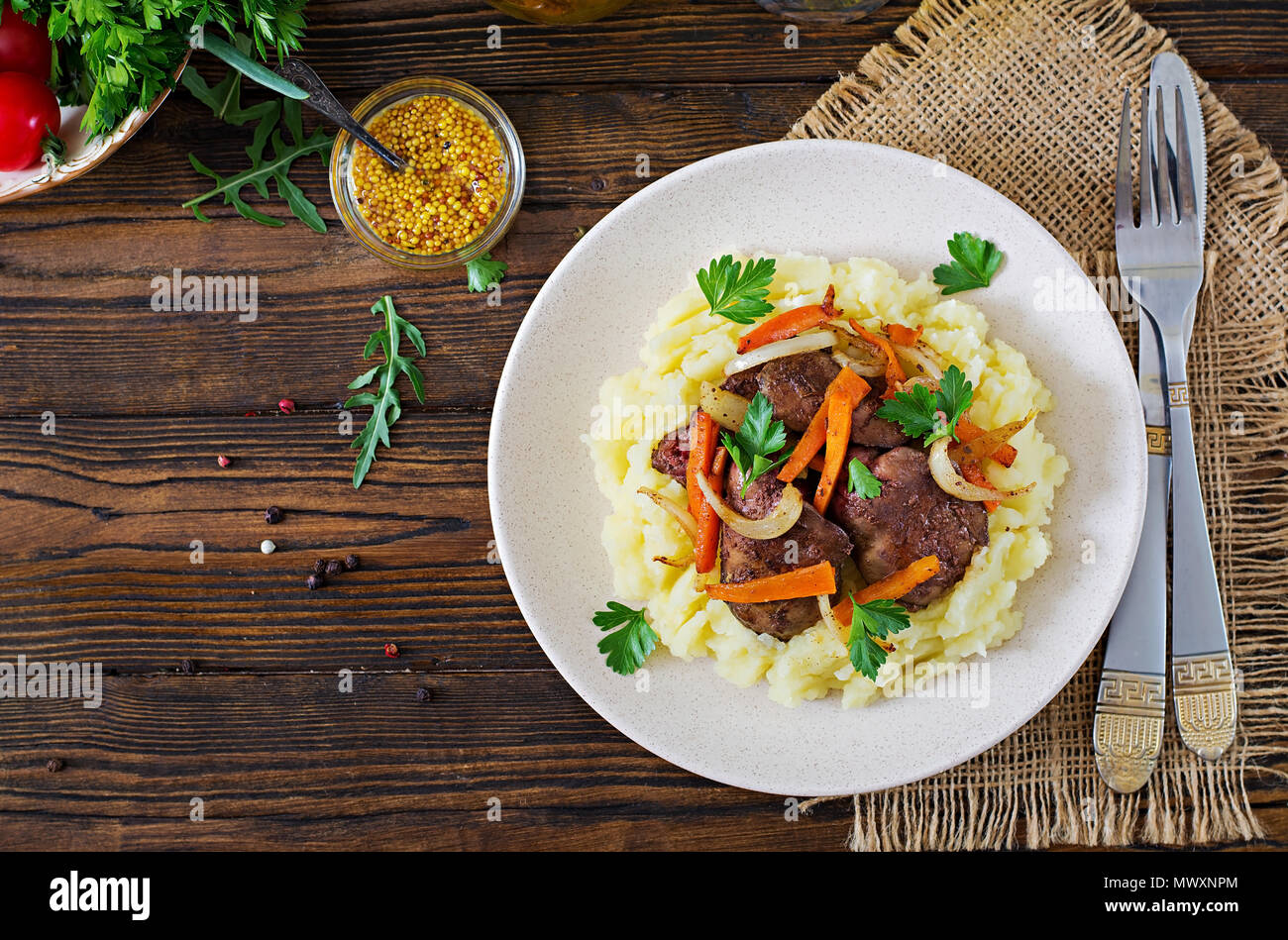 Fried chicken liver with vegetables and garnish of mashed potatoes. Healthy food.Top view. Flat lay Stock Photo