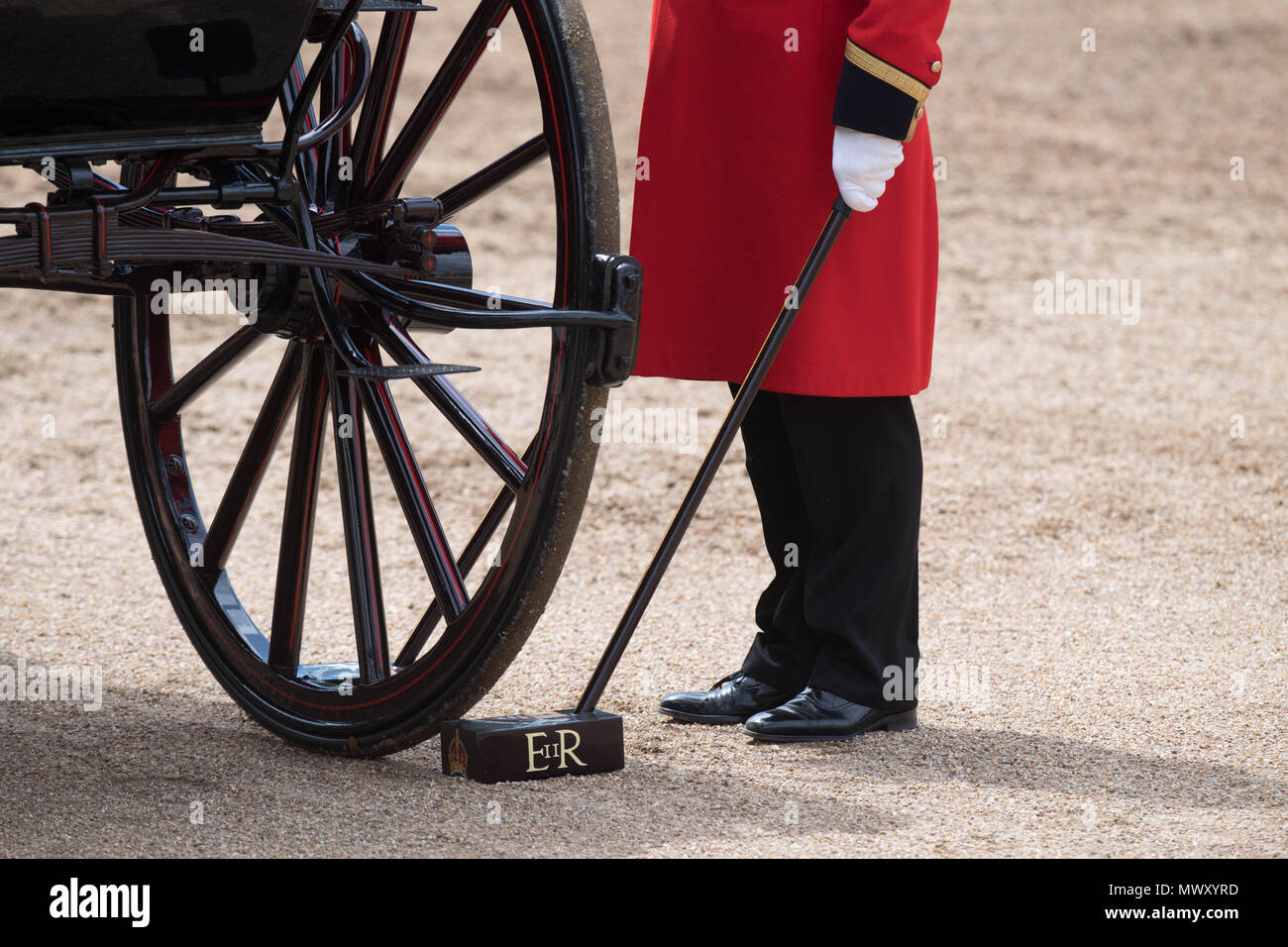 A soldier stands by a carriage during the Colonel's Review, which is the final rehearsal for Trooping the Colour, the Queen's annual birthday parade, in Central London. Stock Photo