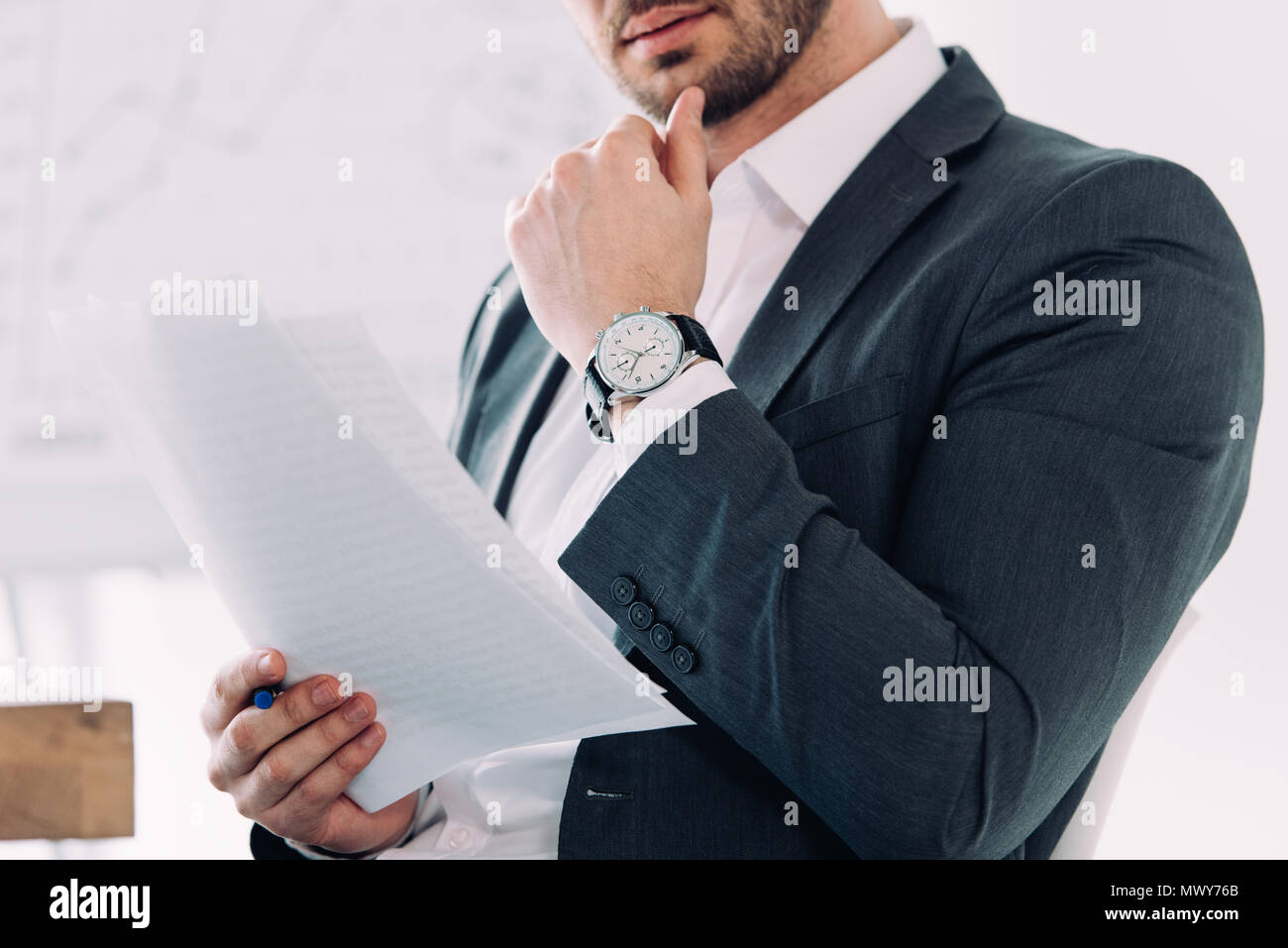 cropped image of businessman reading documents in office Stock Photo