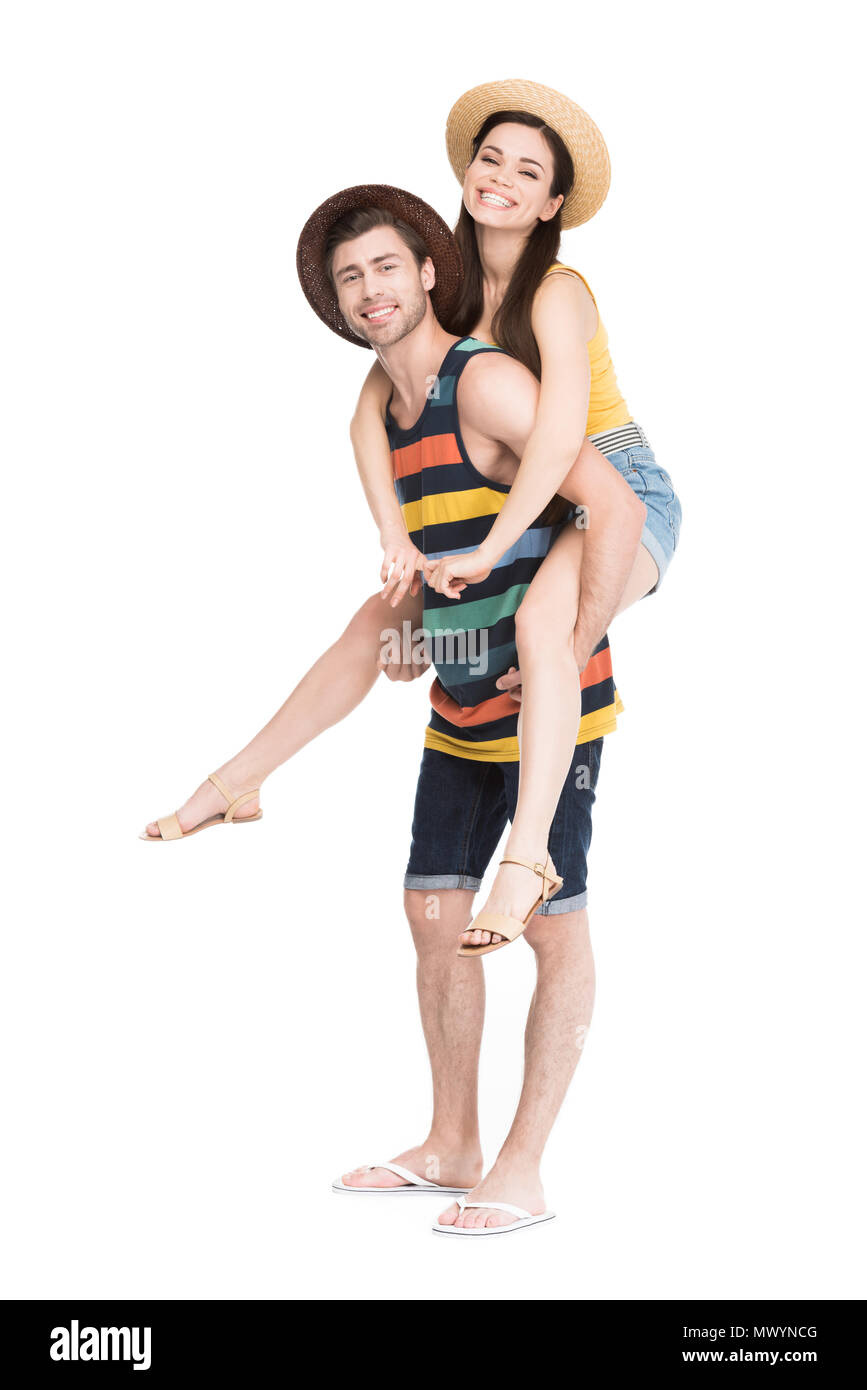 smiling man piggybacking his beautiful girlfriend, isolated on white Stock Photo