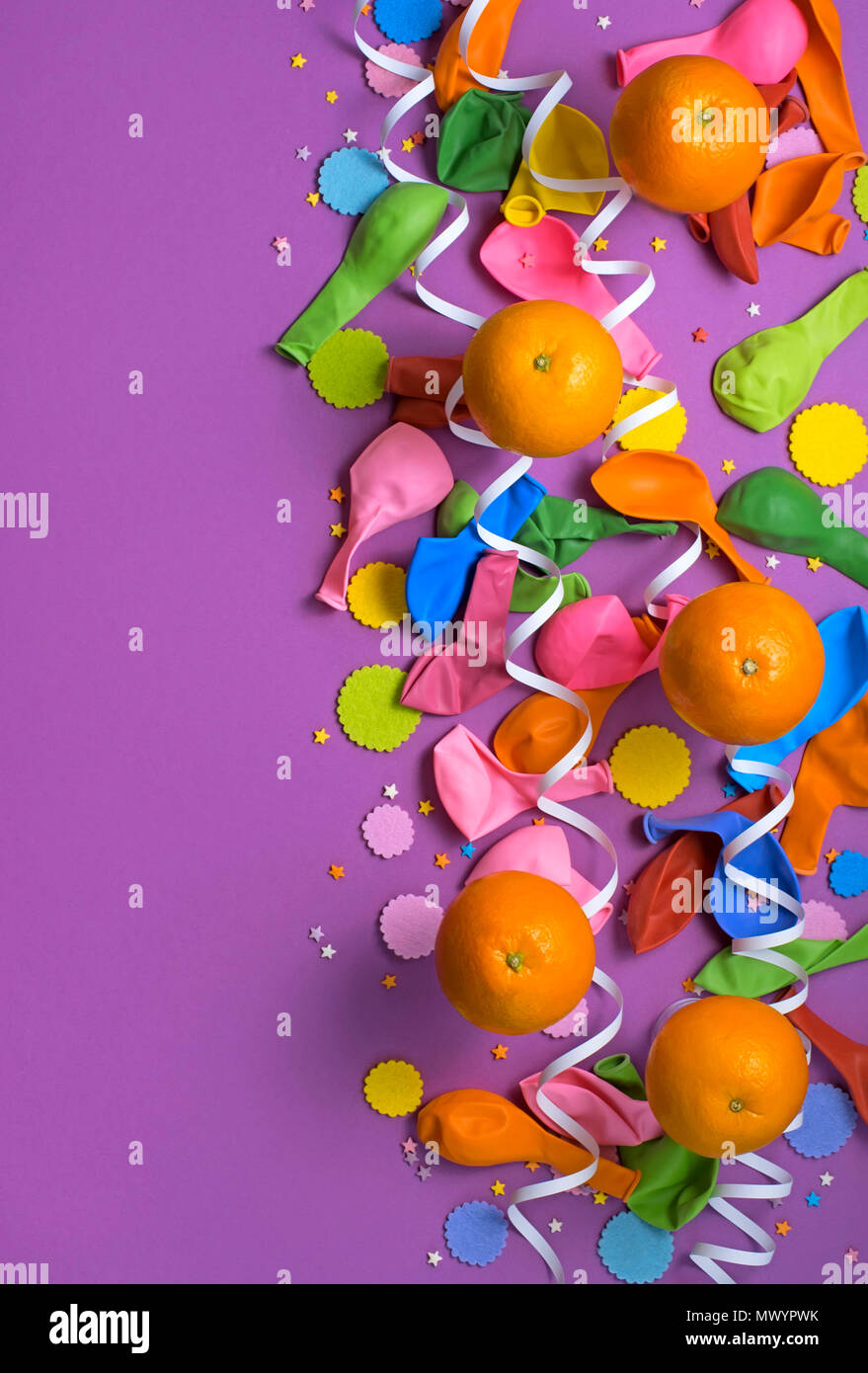 festive poster balloons orange Confetti carnival background ultraviolet. Flat lay top view Stock Photo