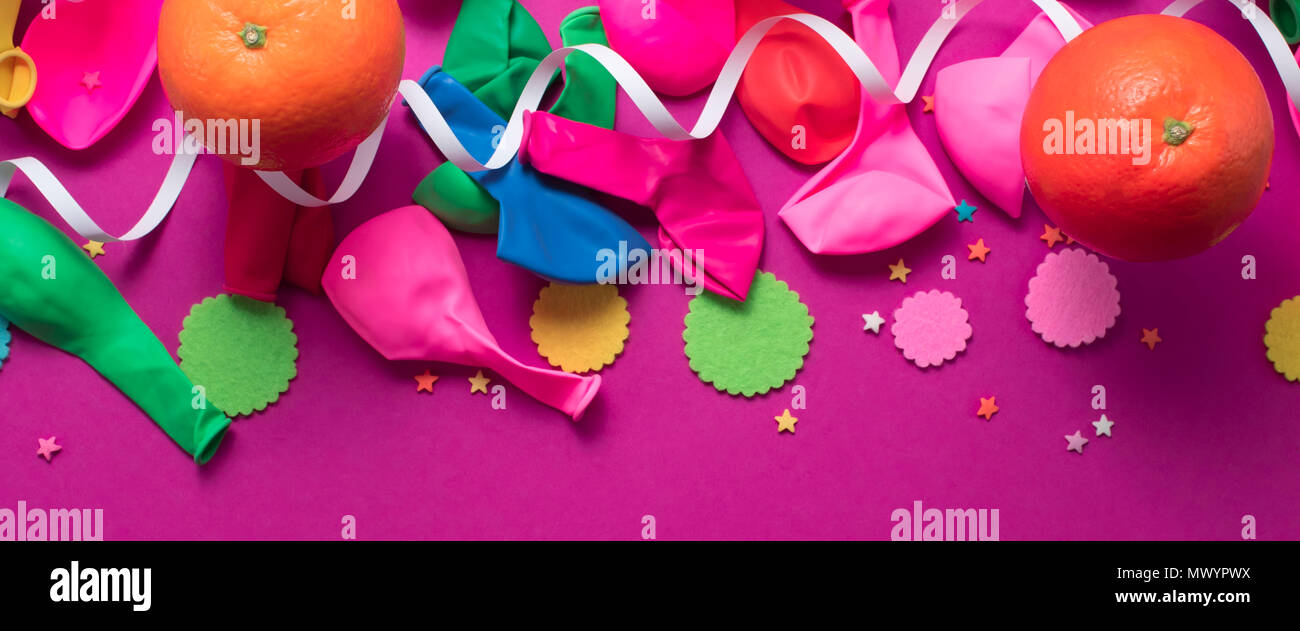 Banner festive poster balloons orange Confetti carnival background ultraviolet. Flat lay top view Stock Photo