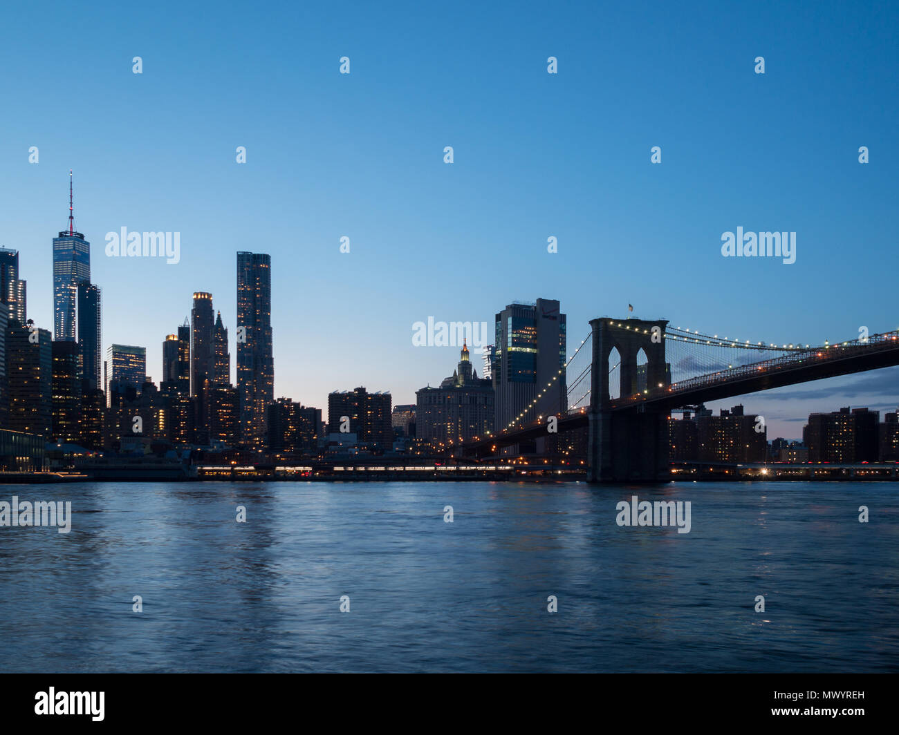 Manhattan skyline and Brooklyn Bridge at sunset Stock Photo - Alamy