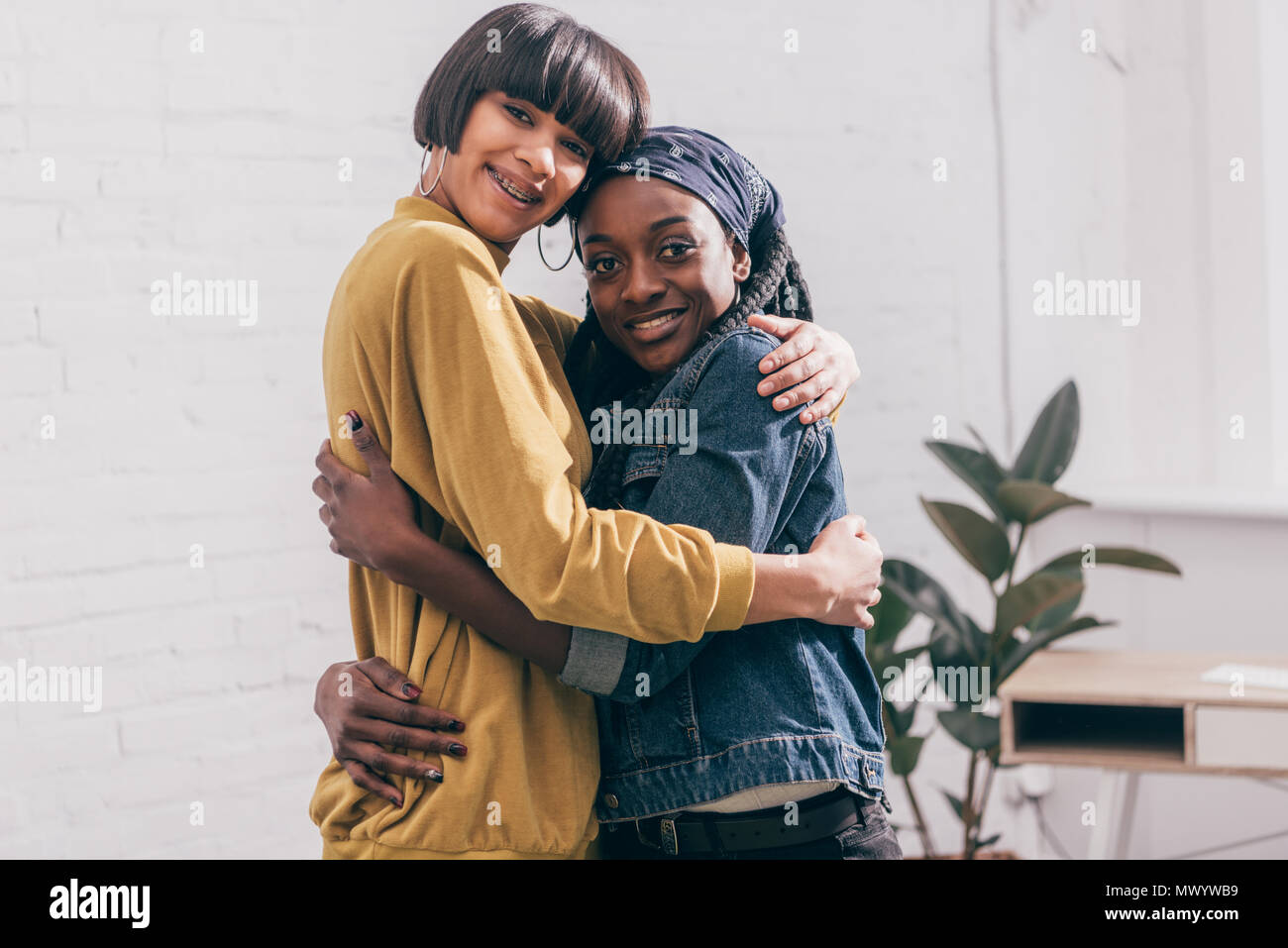 young multicultural female friends hugging each other Stock Photo - Alamy