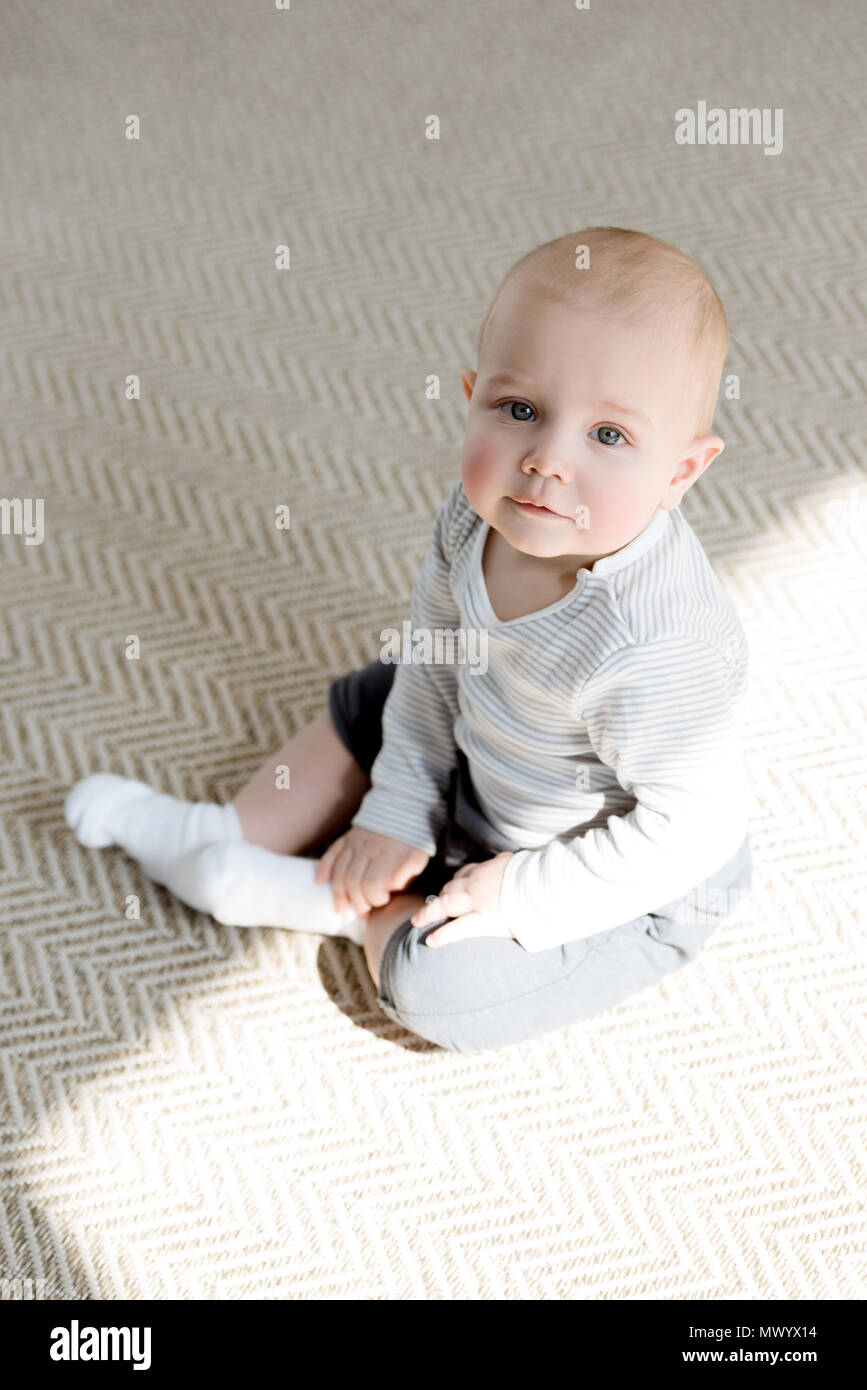adorable little baby boy sitting on floor Stock Photo - Alamy