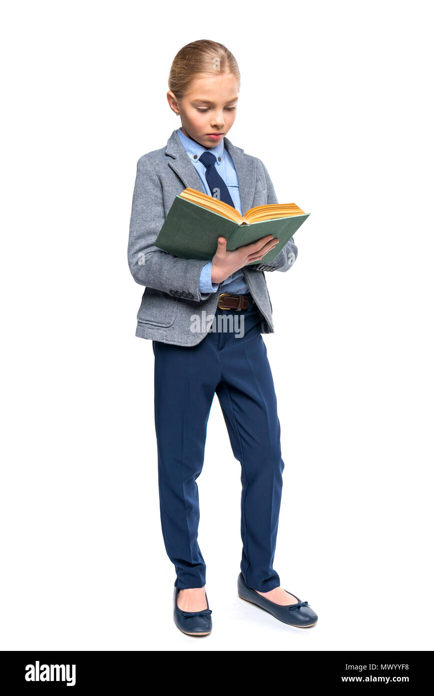 concentrated schoolgirl in reading book, isolated on white Stock Photo ...