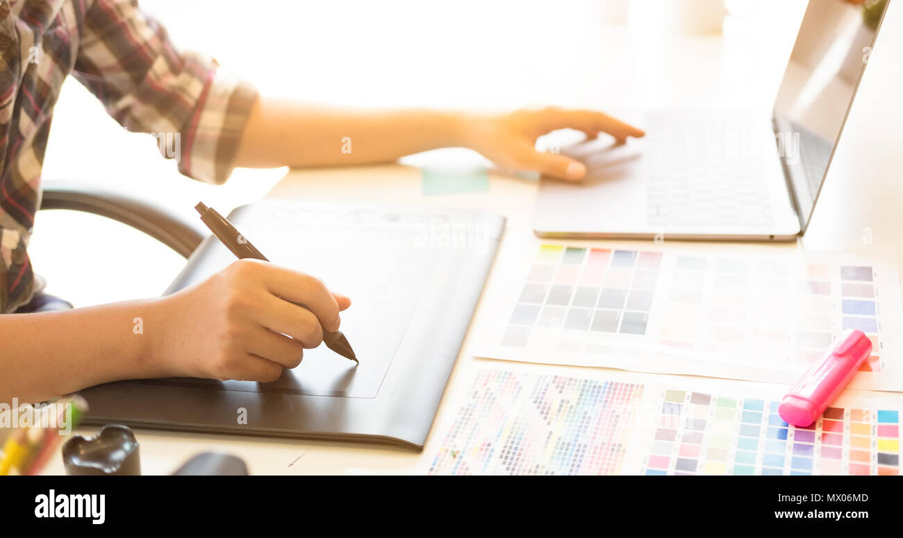 Graphic Designer Using Digital Pen On Tablet With Banner Size And