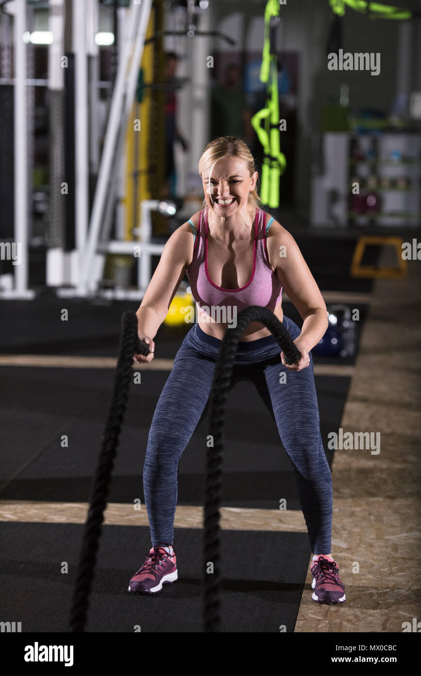 Execise With Rodes young fit athlete woman working out in functional training gym doing ...