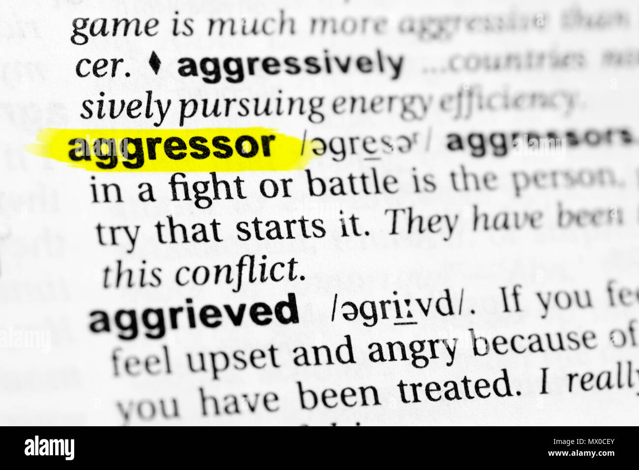 Highlighted English word 'aggressor' and its definition in the dictionary. Stock Photo