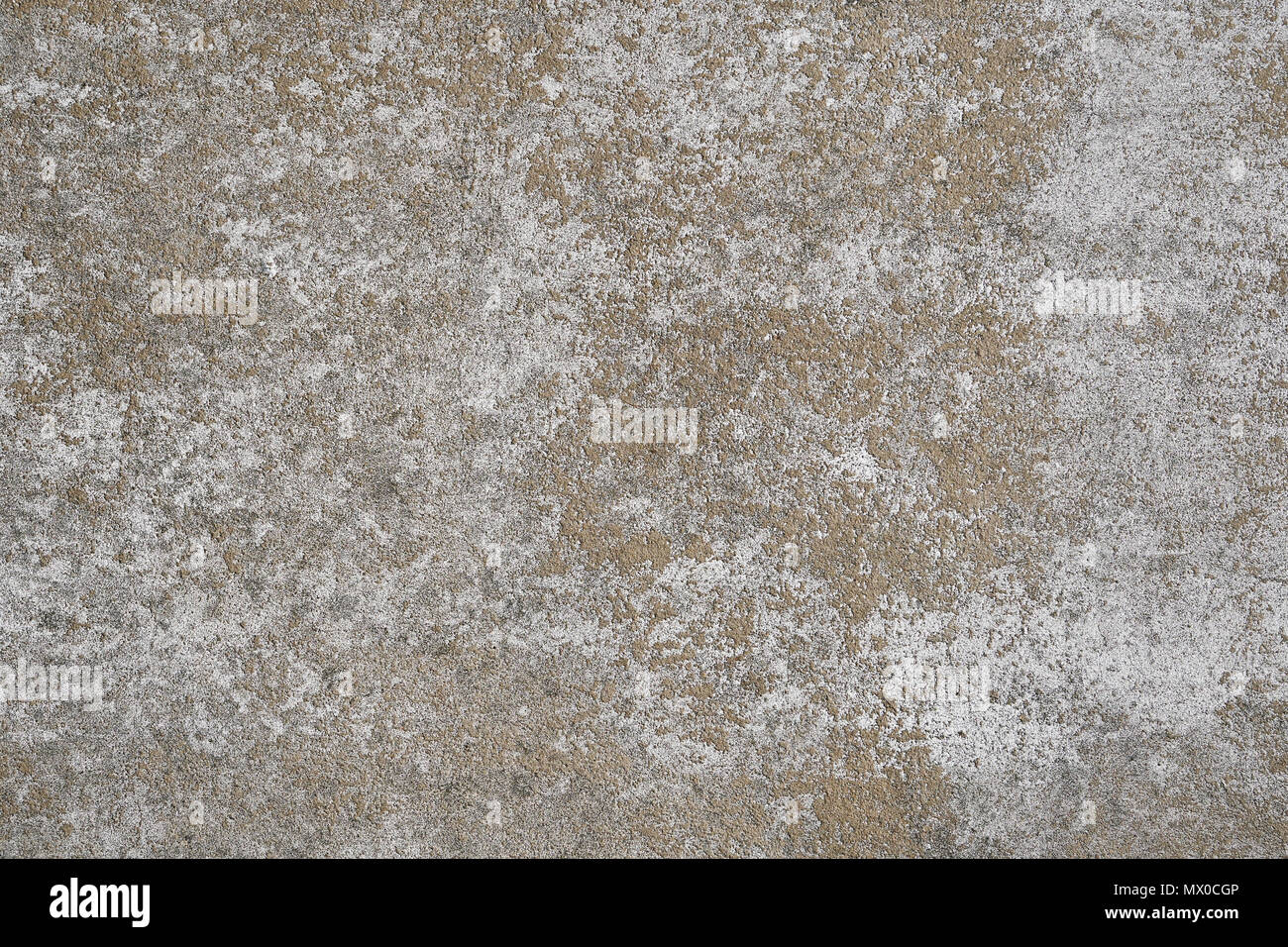 weathered concrete stone wall background texture pattern with white paint mostly peeled off Stock Photo