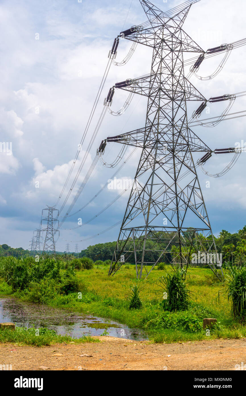 High Tension electrical lines passing through rural region of Kerala, South  India Stock Photo - Alamy