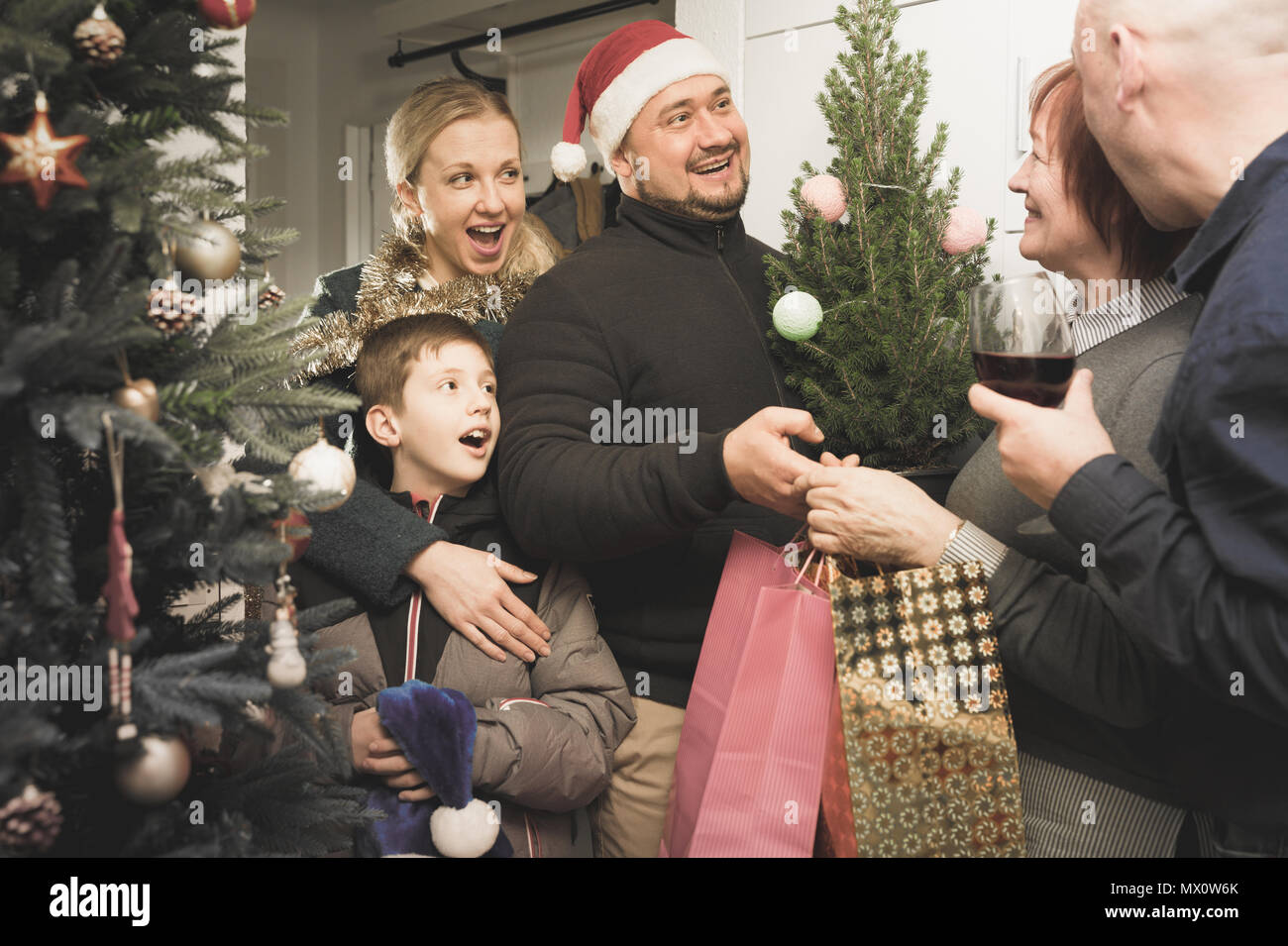 Family coming with presents to elderly mother for celebrating New Year together Stock Photo