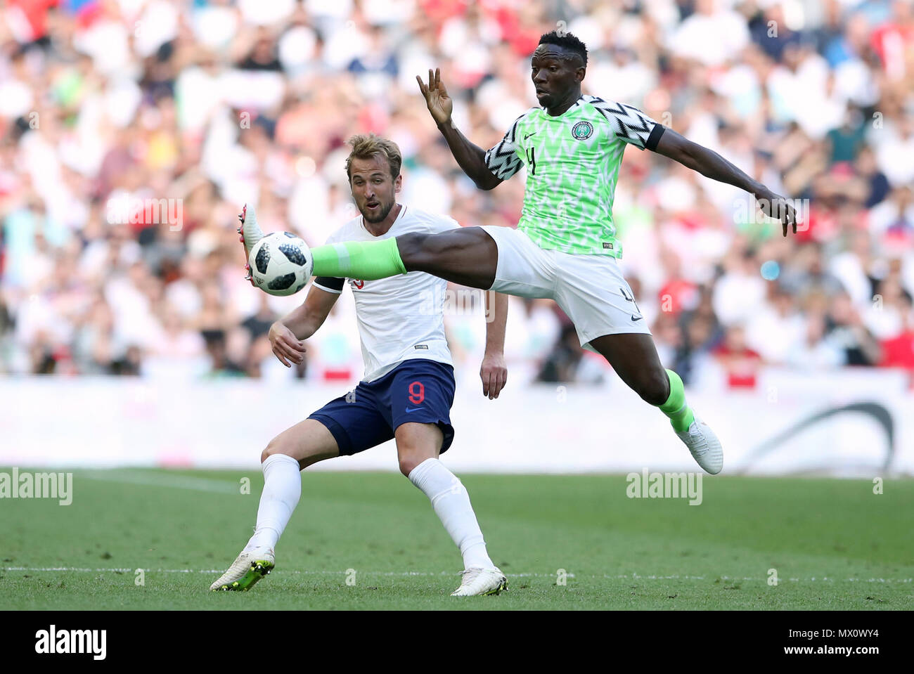 England's Harry Kane (left) and Nigeria's Kenneth Omeruo battle for the ball during the International Friendly match at Wembley Stadium, London. Stock Photo