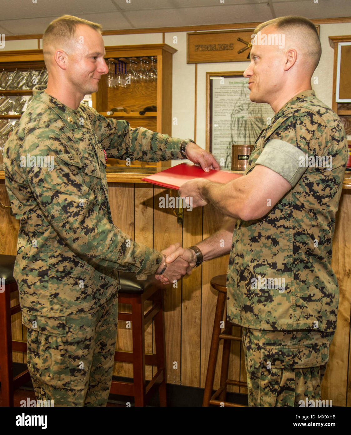 U.S. Marine Corps Lt. Col. James W. Lively, right, former commanding officer, Battalion Landing Team, 26th Marine Corps Expeditionary Unit, presents the Bronze Star with 'V' device for valor to U.S. Marine Corps Maj. David J. Palka, assistant battalion inspector-instructor, 5th Battalion, 14th Marine Regiment, 4th Marine Division, left, during a Bronze Star Presentation on Camp Pendleton, Calif., May 1, 2017. Maj. Palka received the Bronze Star for heroic service in connection with combat operations against the enemy while serving as a Commander, Battery E, Battalion Landing Team, 2nd Battalio Stock Photo