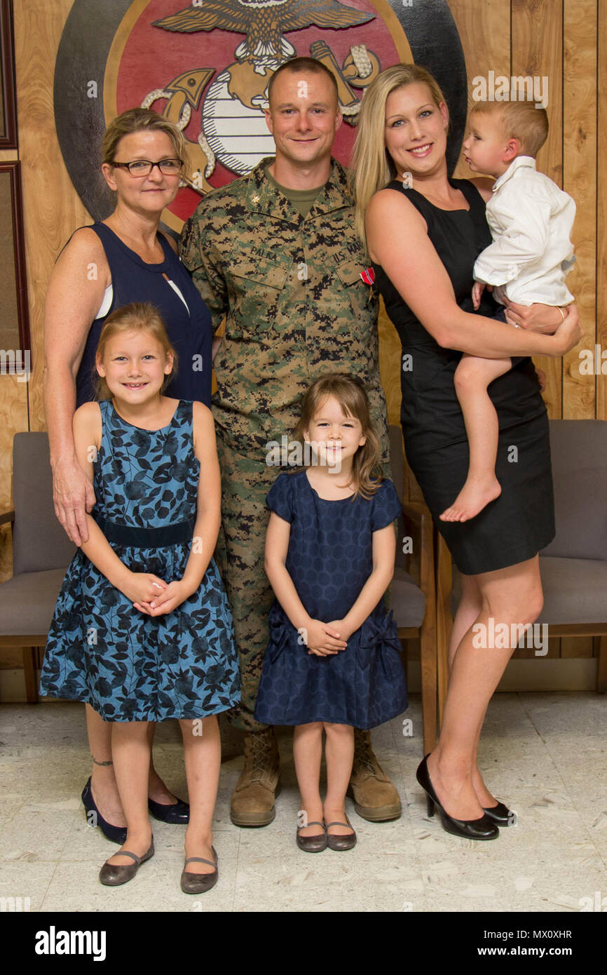 U.S. Marine Corps Maj. David J. Palka, assistant battalion inspector-instructor, 5th Battalion, 14th Marine Regiment, 4th Marine Division, and his family celebrate his achievement of earning the Bronze Star with 'V' device for valor, during a Bronze Star Presentation on Camp Pendleton, Calif., May 1, 2017. Maj. Palka received the Bronze Star for heroic service in connection with combat operations against the enemy while serving as a Commander, Battery E, Battalion Landing Team, 2nd Battalion 6th Marine Regiment, 26th Marine Expeditionary Unit, in support of Operation Inherent Resolve from 12 M Stock Photo