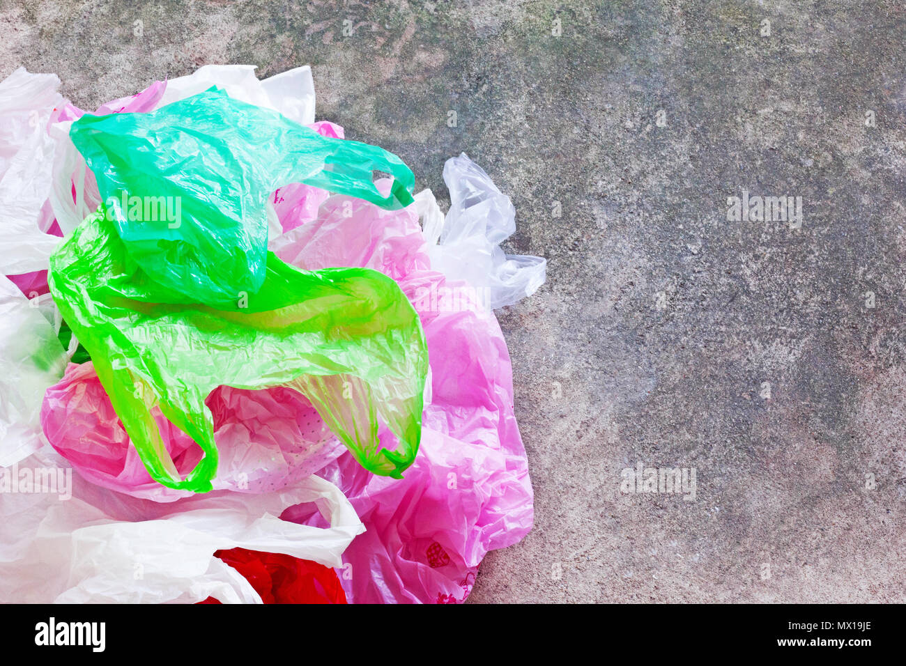 Colorful plastic bag on cement floor background. Stock Photo