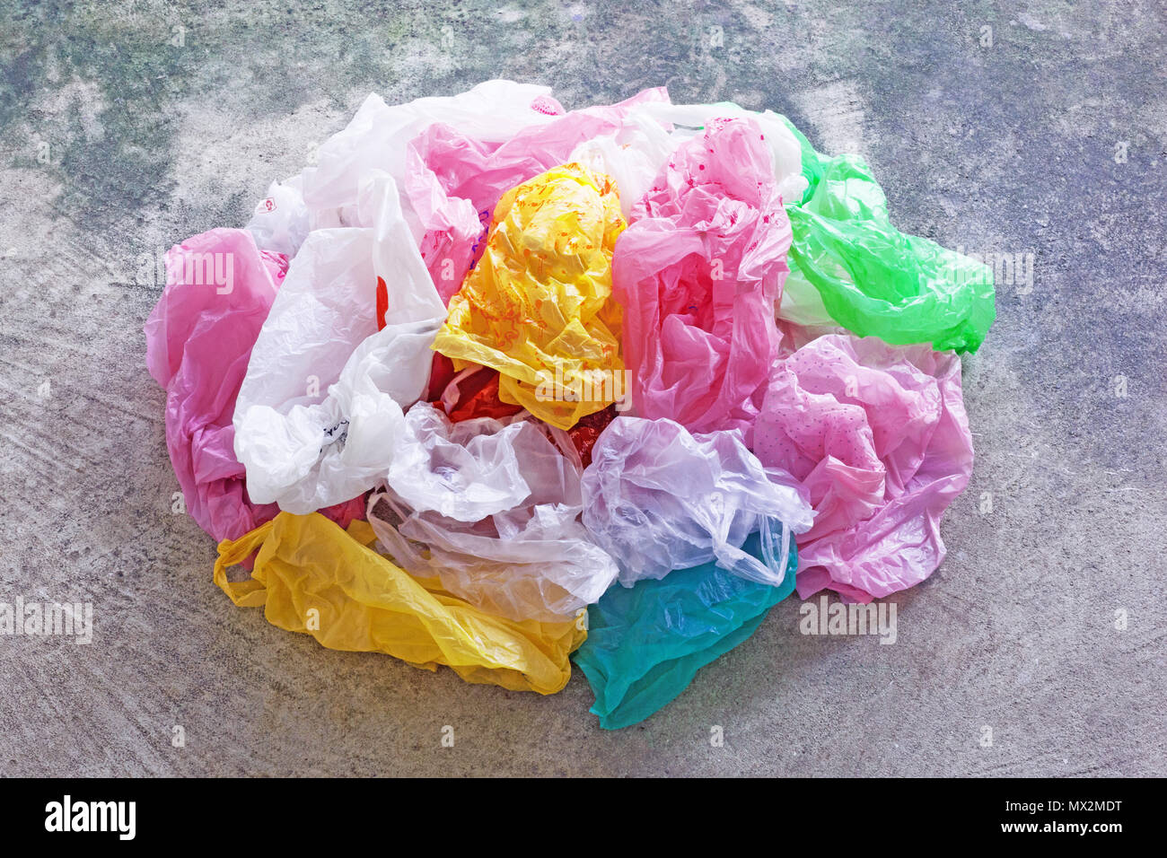 Colorful plastic bag on cement floor background. Stock Photo