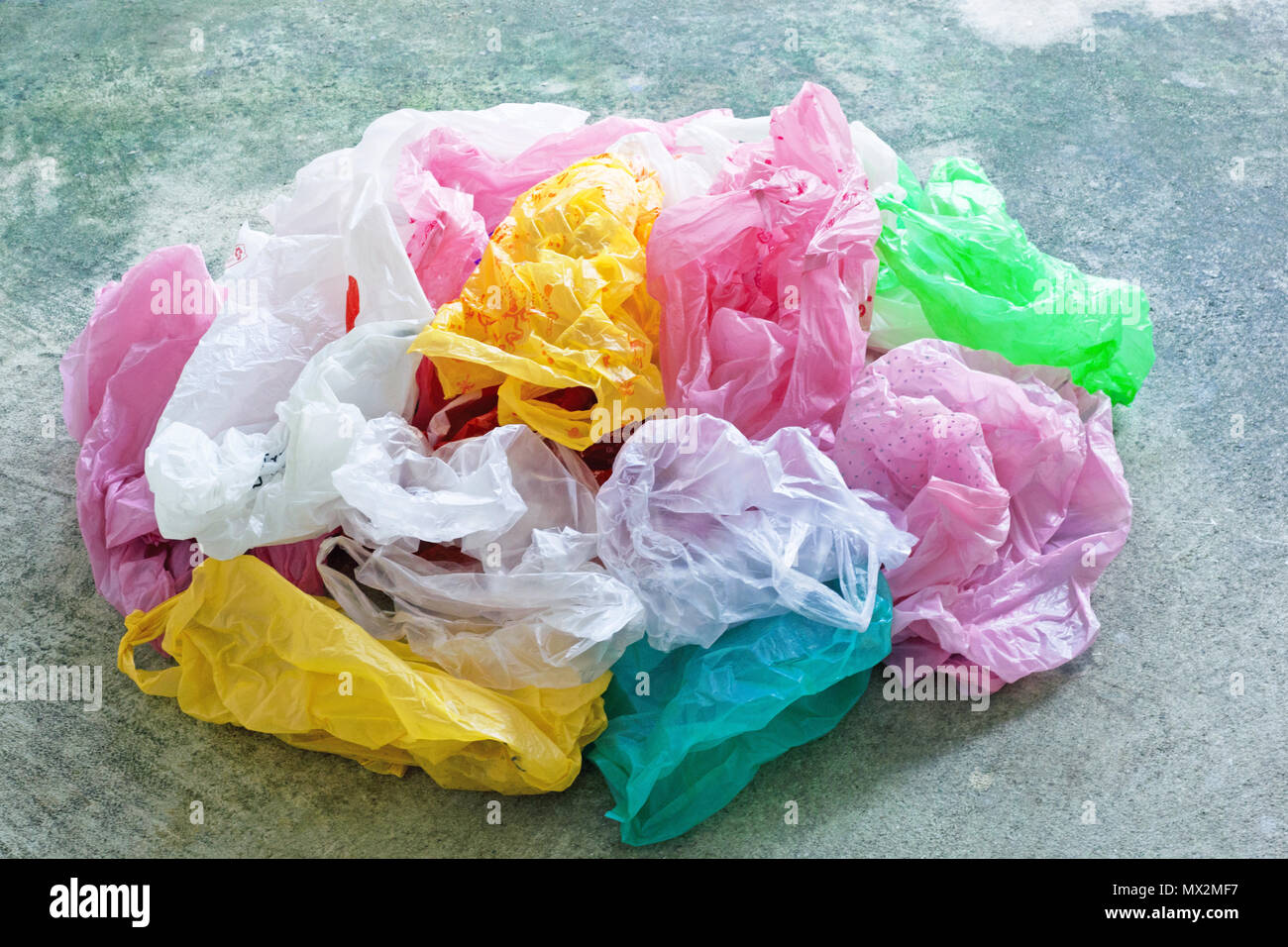 Colorful plastic bag on cement floor background. Stock Photo
