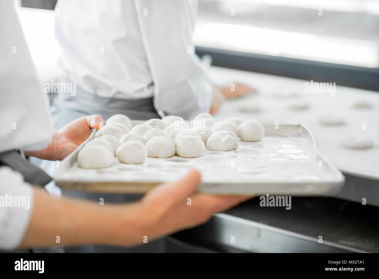 Holding tray with dough Stock Photo
