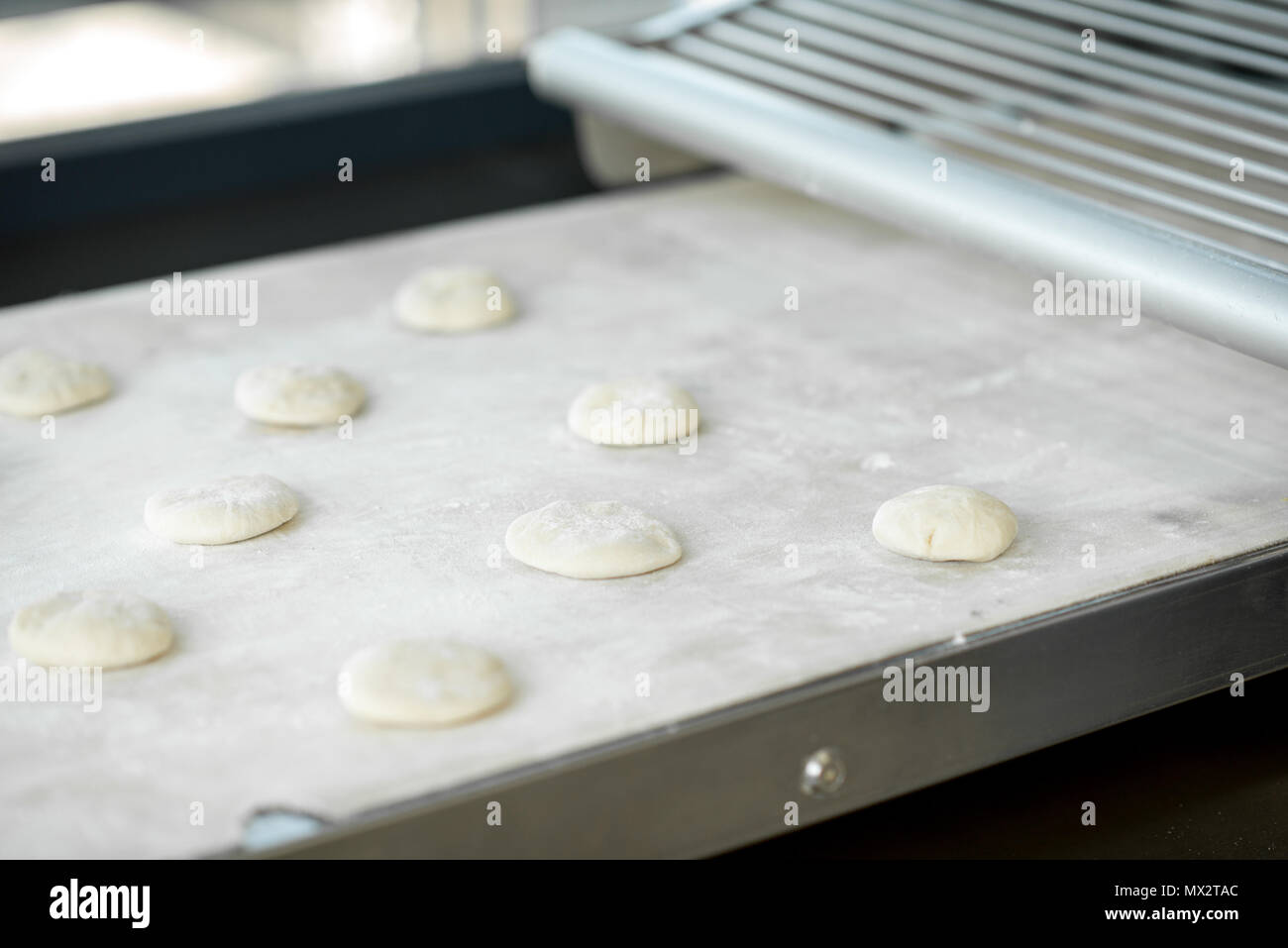 Dough on the rolling machine Stock Photo