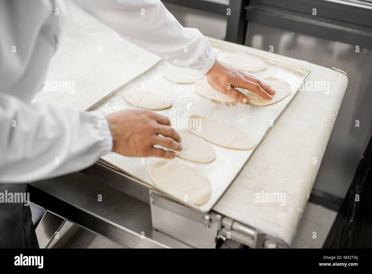 Working with raw dough at the manufacturing Stock Photo