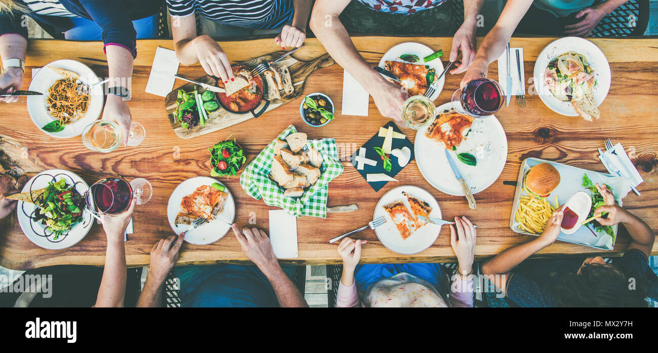 eating and leisure concept - group of people having dinner at table